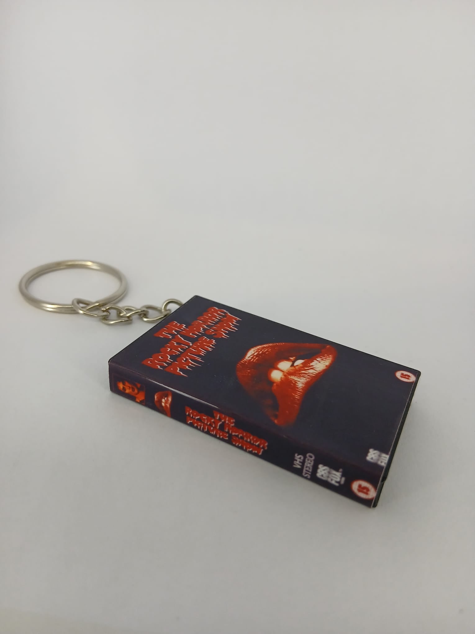 The Rocky Horror Picture Show VHS keyring — front cover standing angled