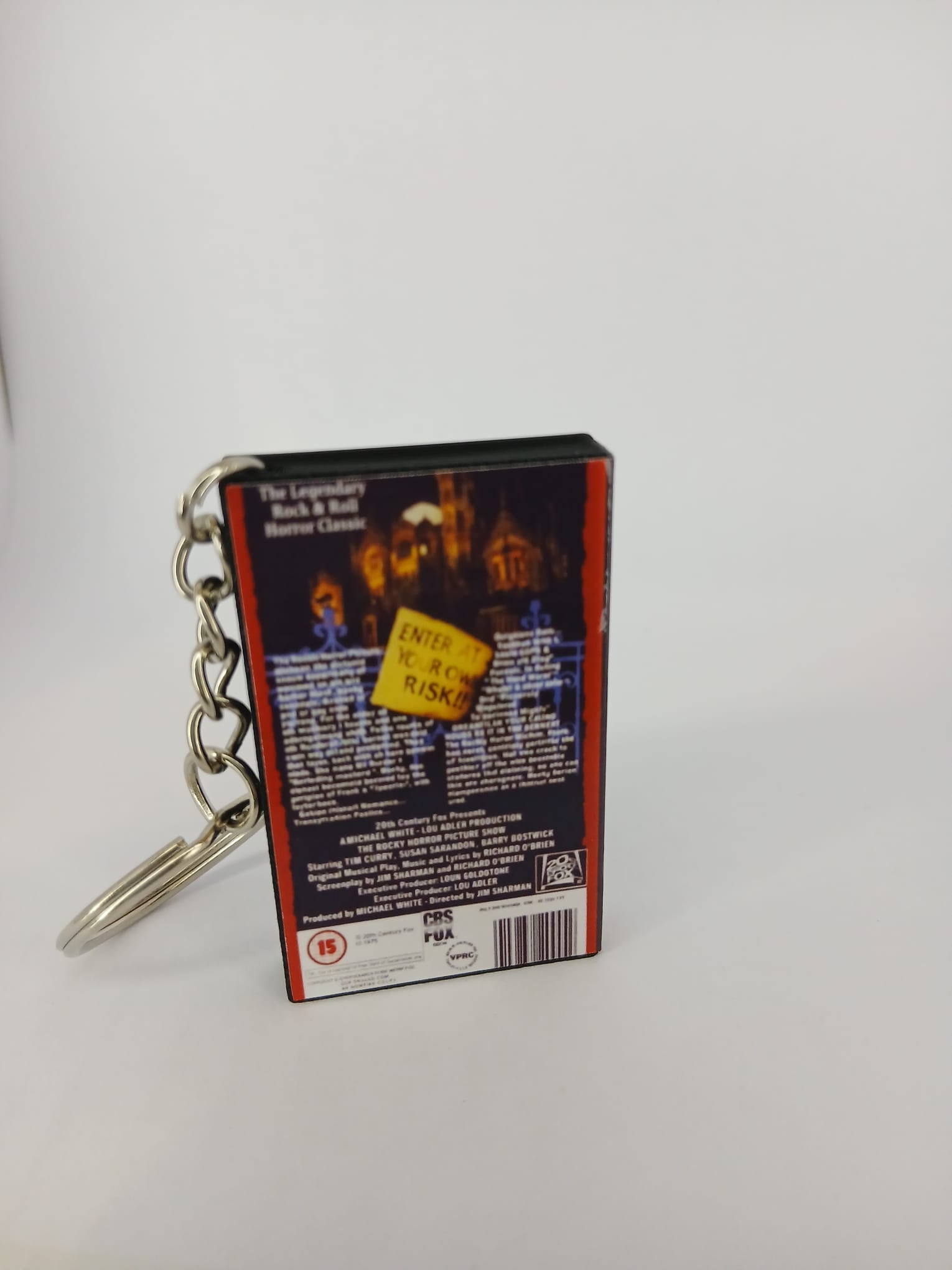 The Rocky Horror Picture Show VHS keyring — spine and back angled view standing 2