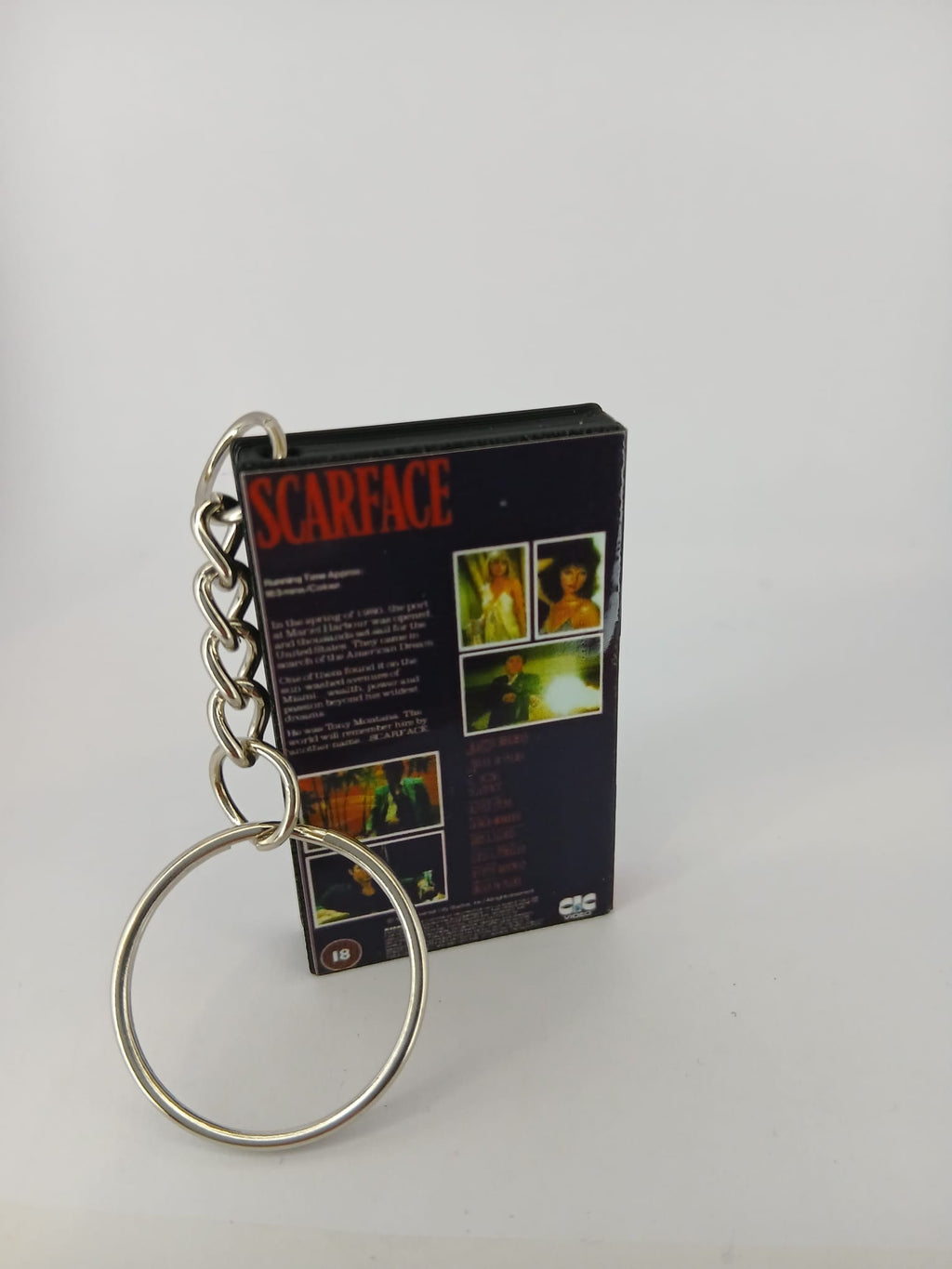 Scarface VHS keyring — front cover standing with coin for scale