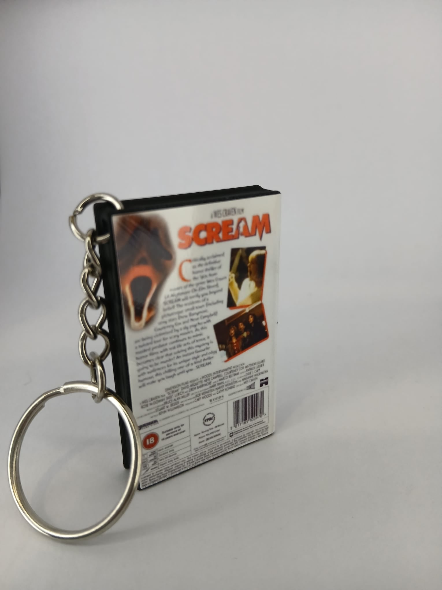 Scream VHS keyring — spine view standing