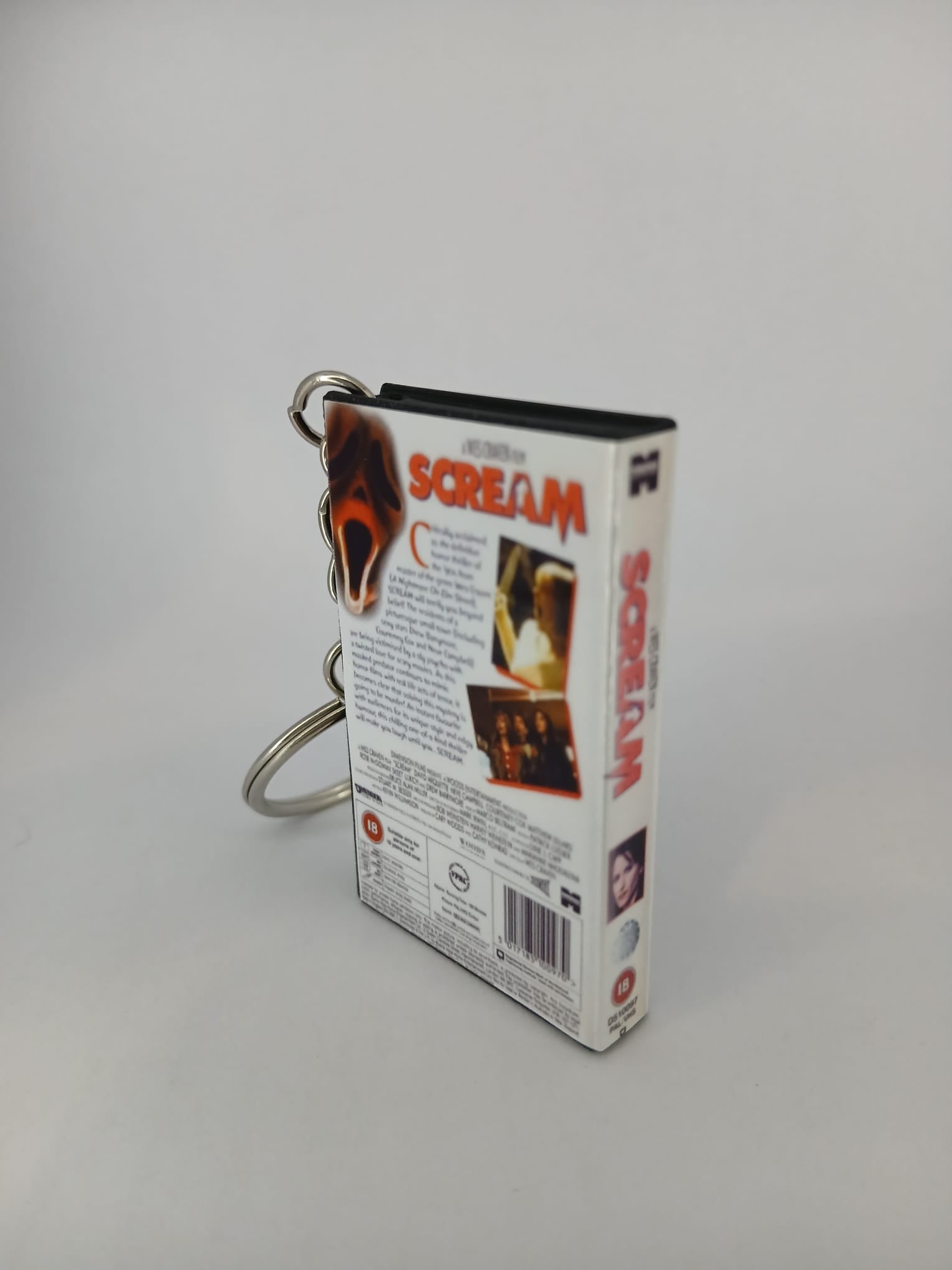 Scream VHS keyring — spine view standing 2