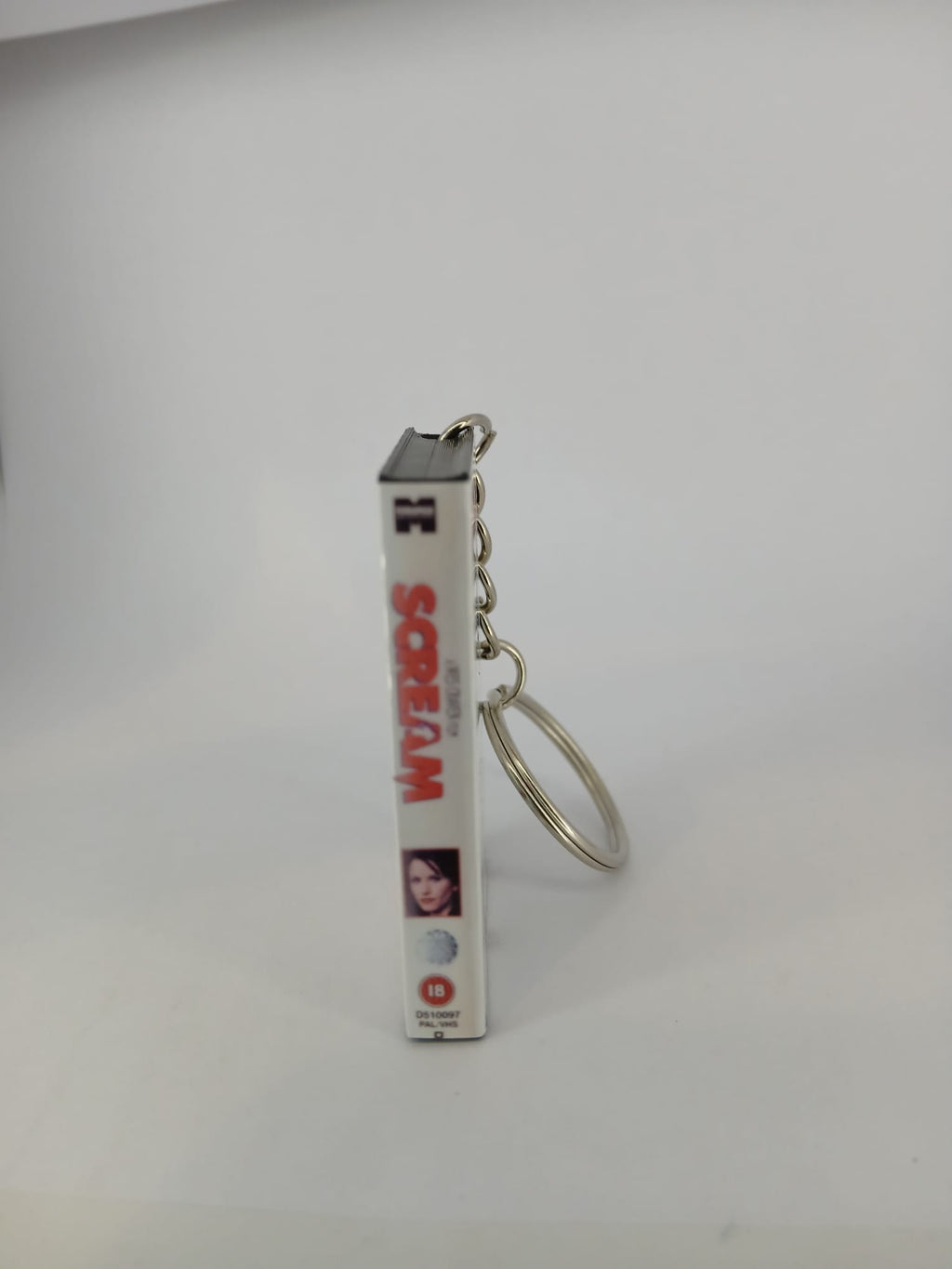 Scream VHS keyring — front and spine angled view standing