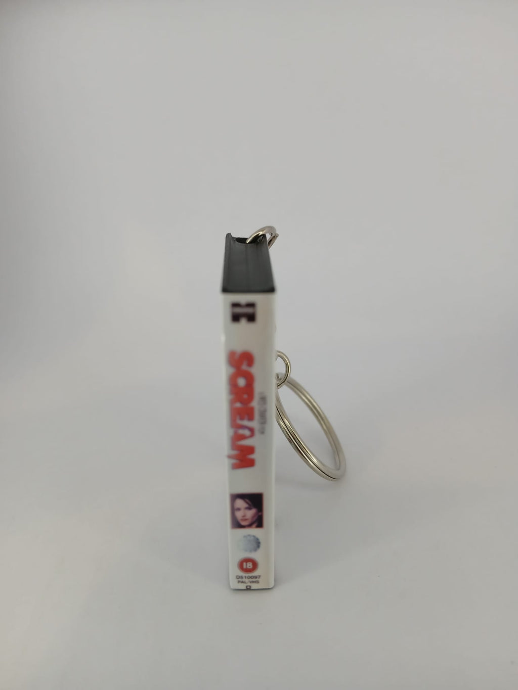 Scream VHS keyring — front cover standing angled