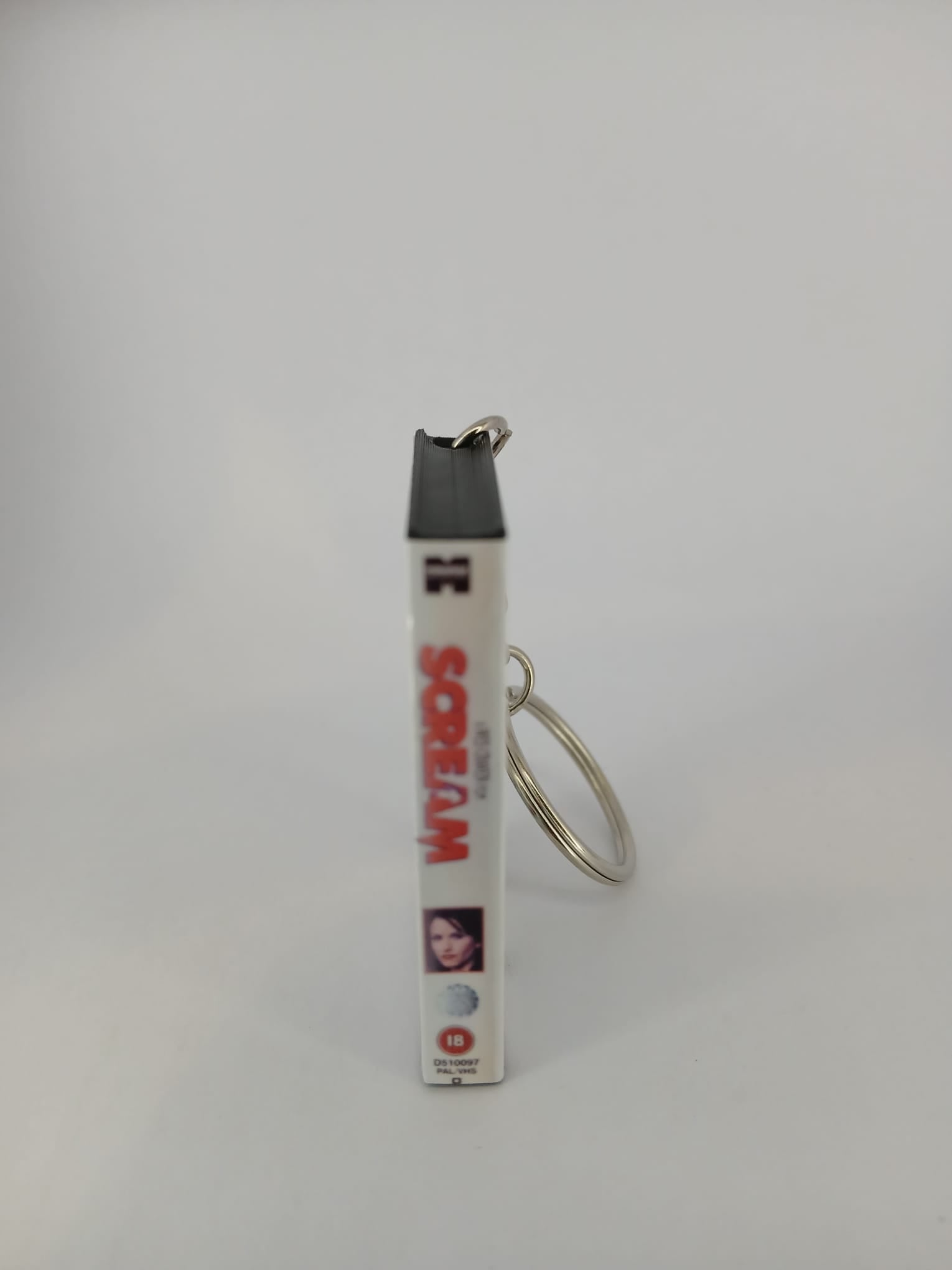 Scream VHS keyring — front cover standing angled