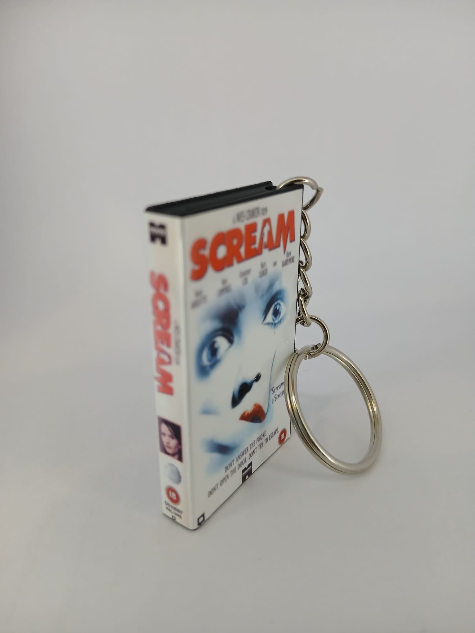 Scream VHS keyring — front cover standing angled 2