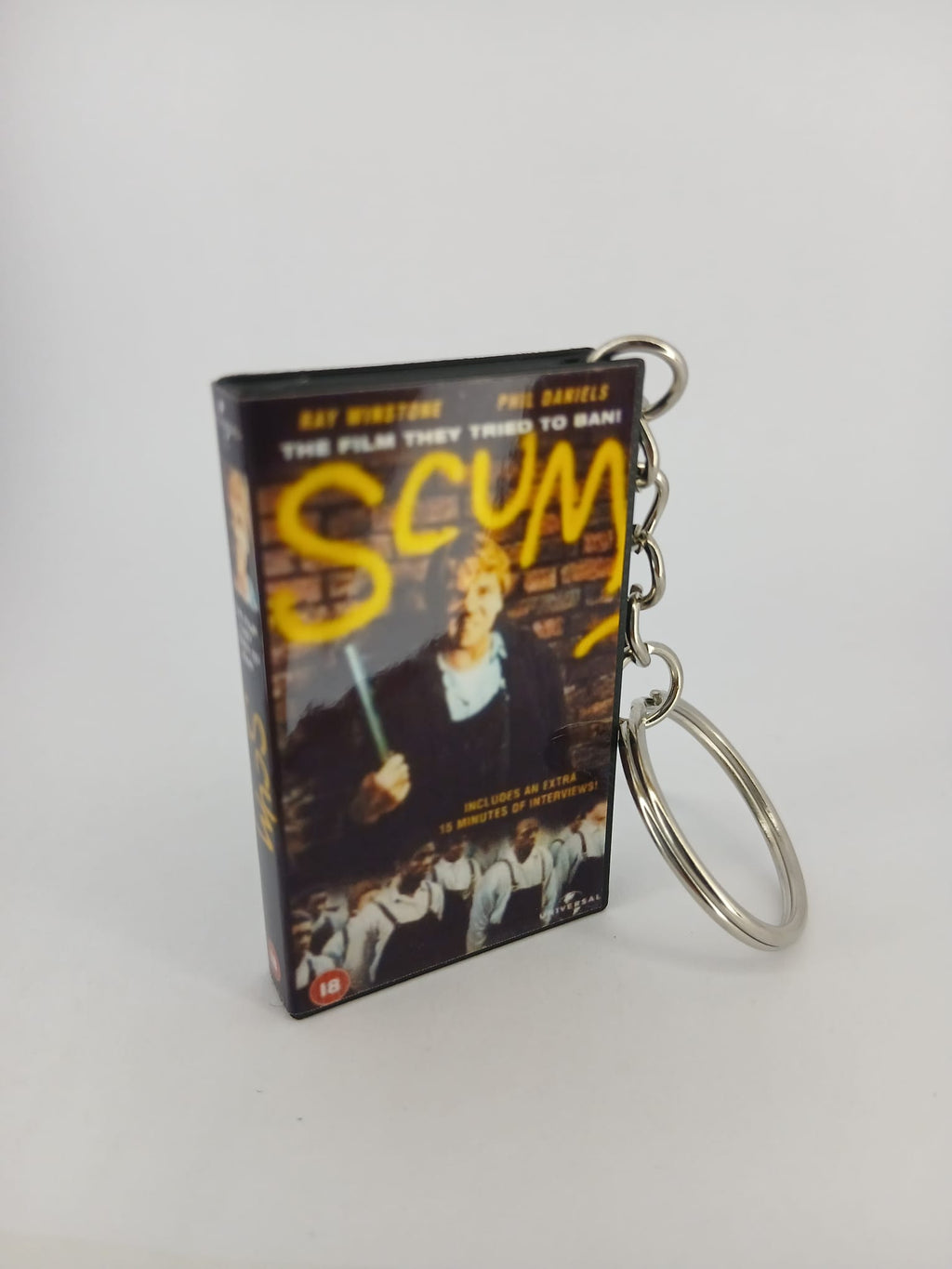 Scum VHS keyring — back cover angled view standing