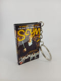 Scum VHS keyring — back cover angled view standing