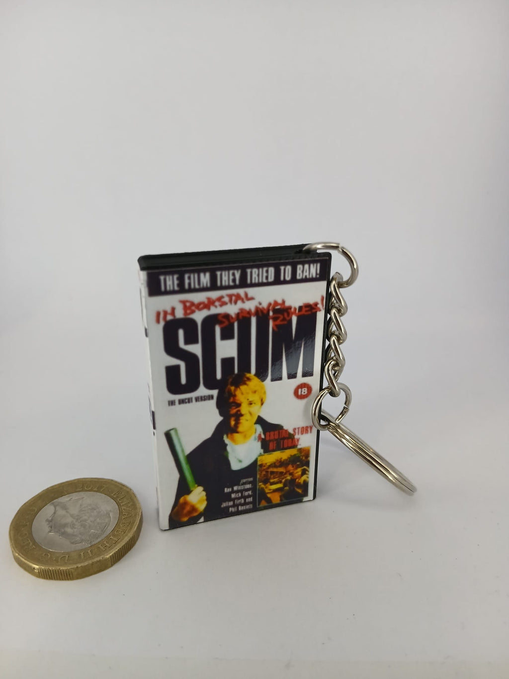Scum VHS keyring — spine view standing