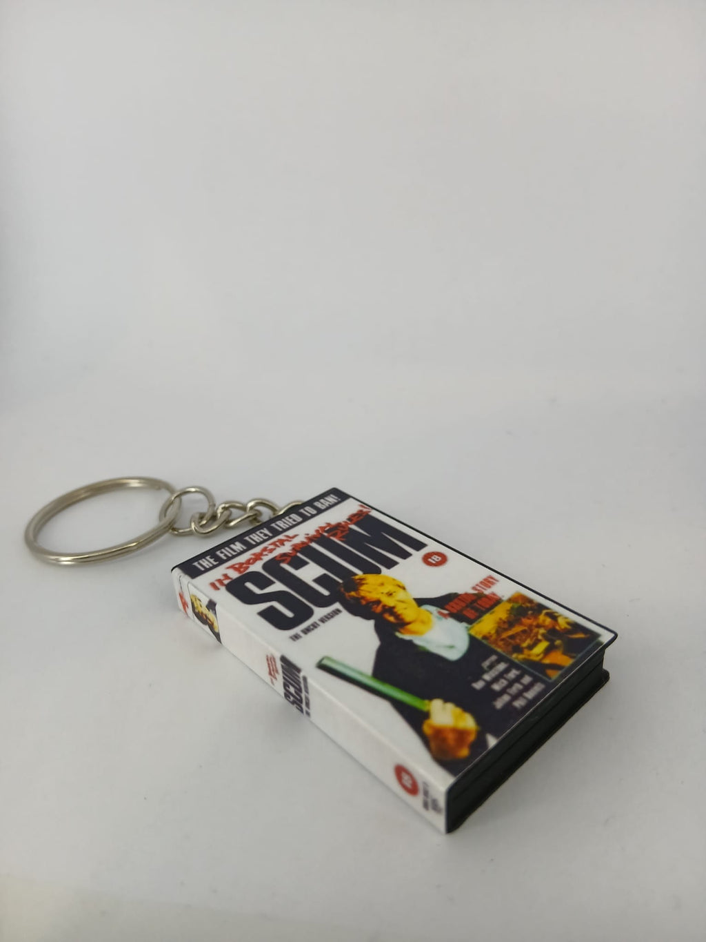 Scum VHS keyring — flat lay front and spine angled