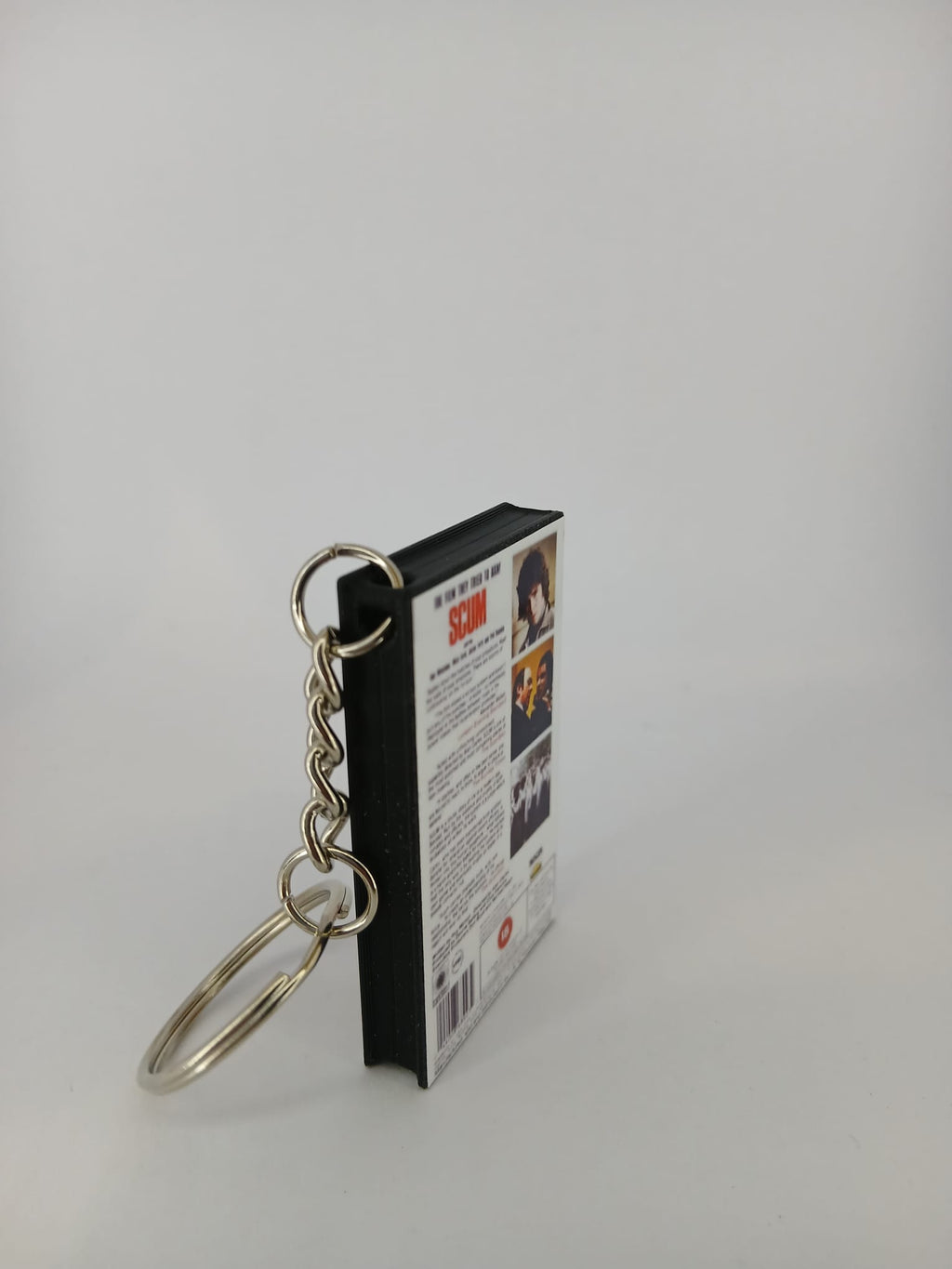Scum VHS keyring — front and spine angled view standing