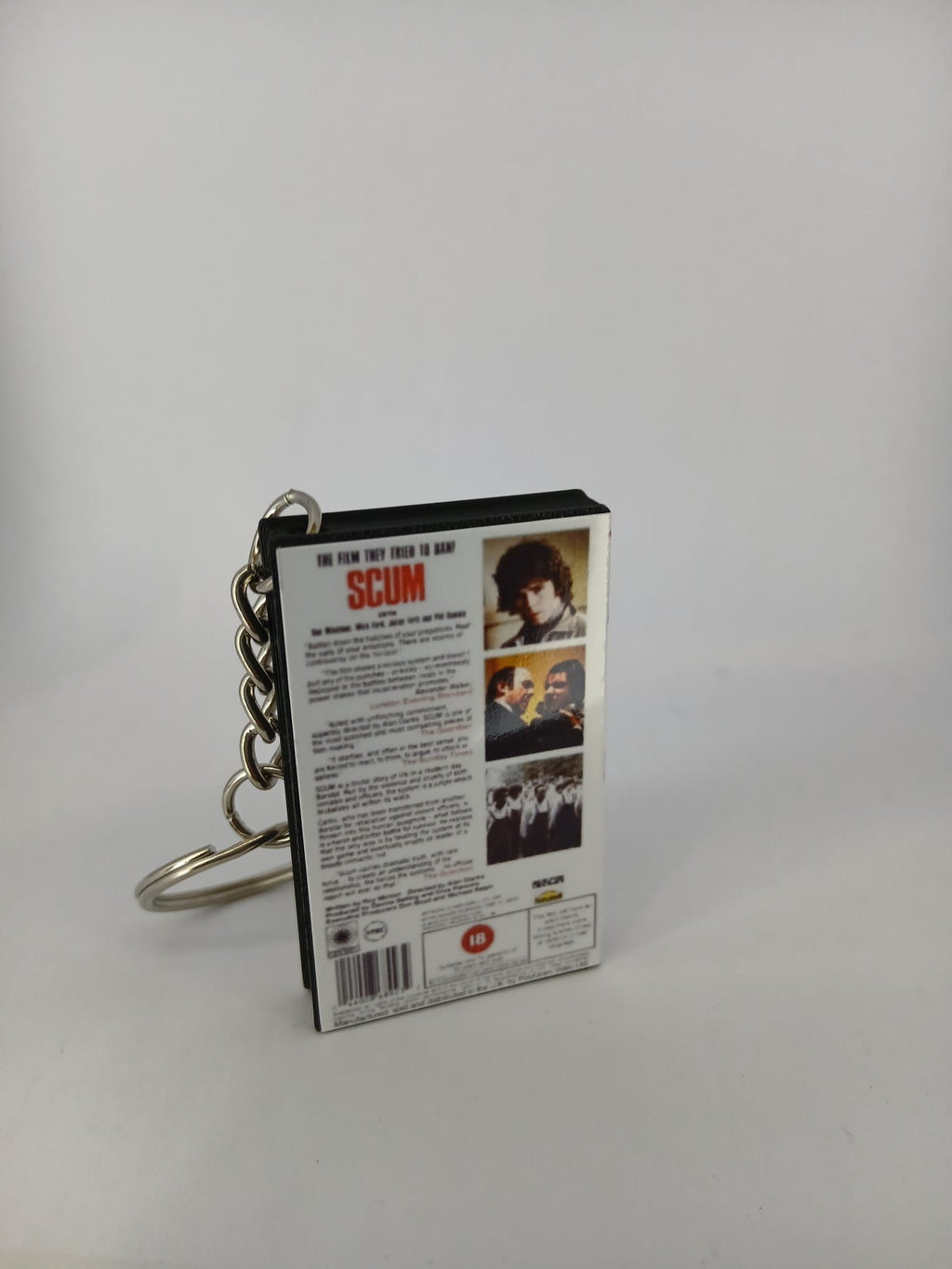 Scum VHS keyring — front cover standing angled