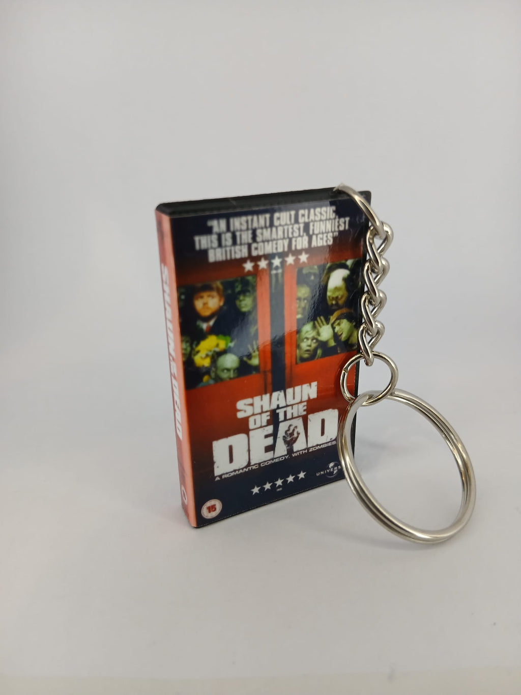 Shaun of the Dead VHS keyring — front cover standing with coin for scale