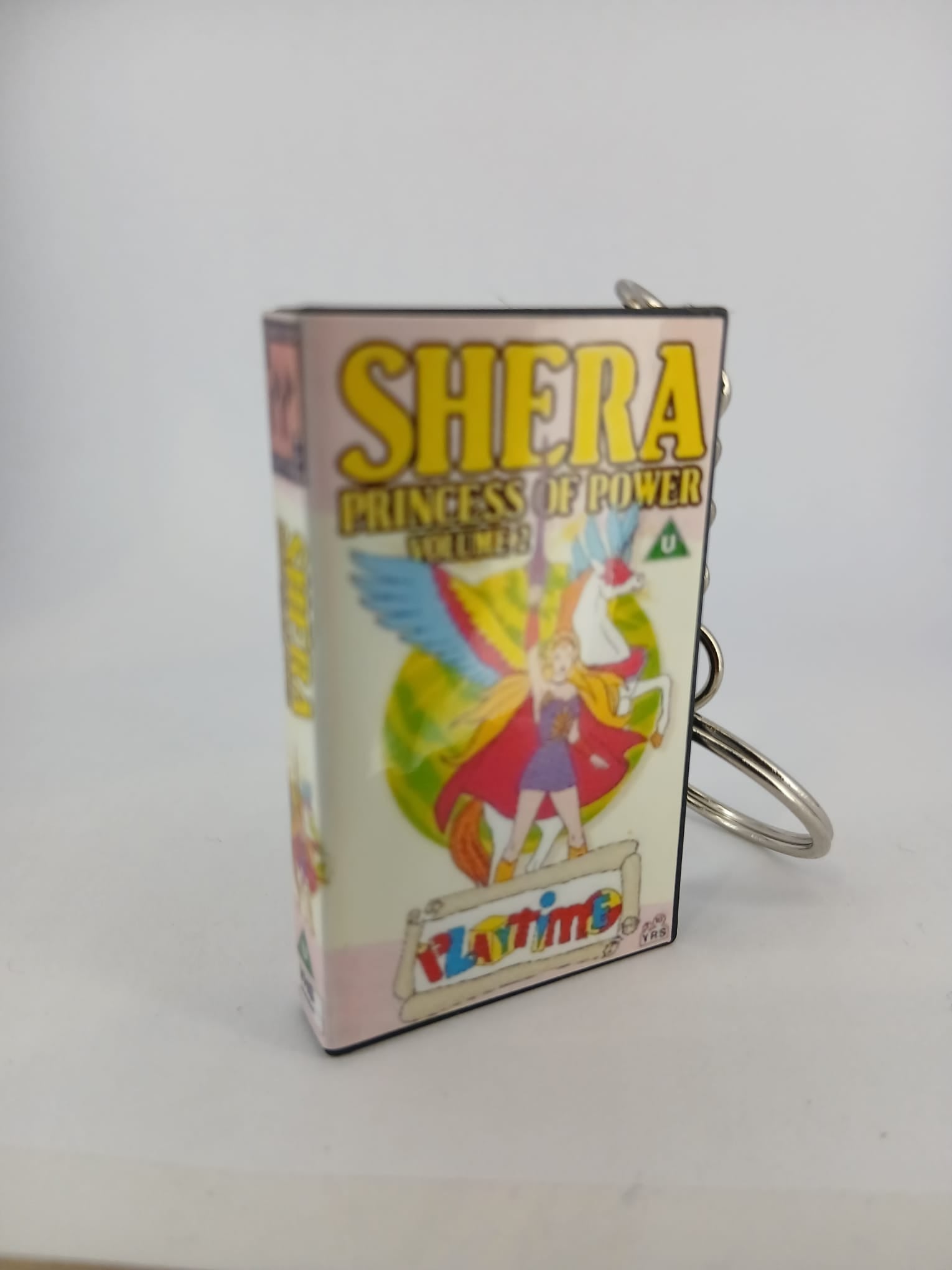 She-Ra Princess of Power VHS keyring — front and spine angled view standing