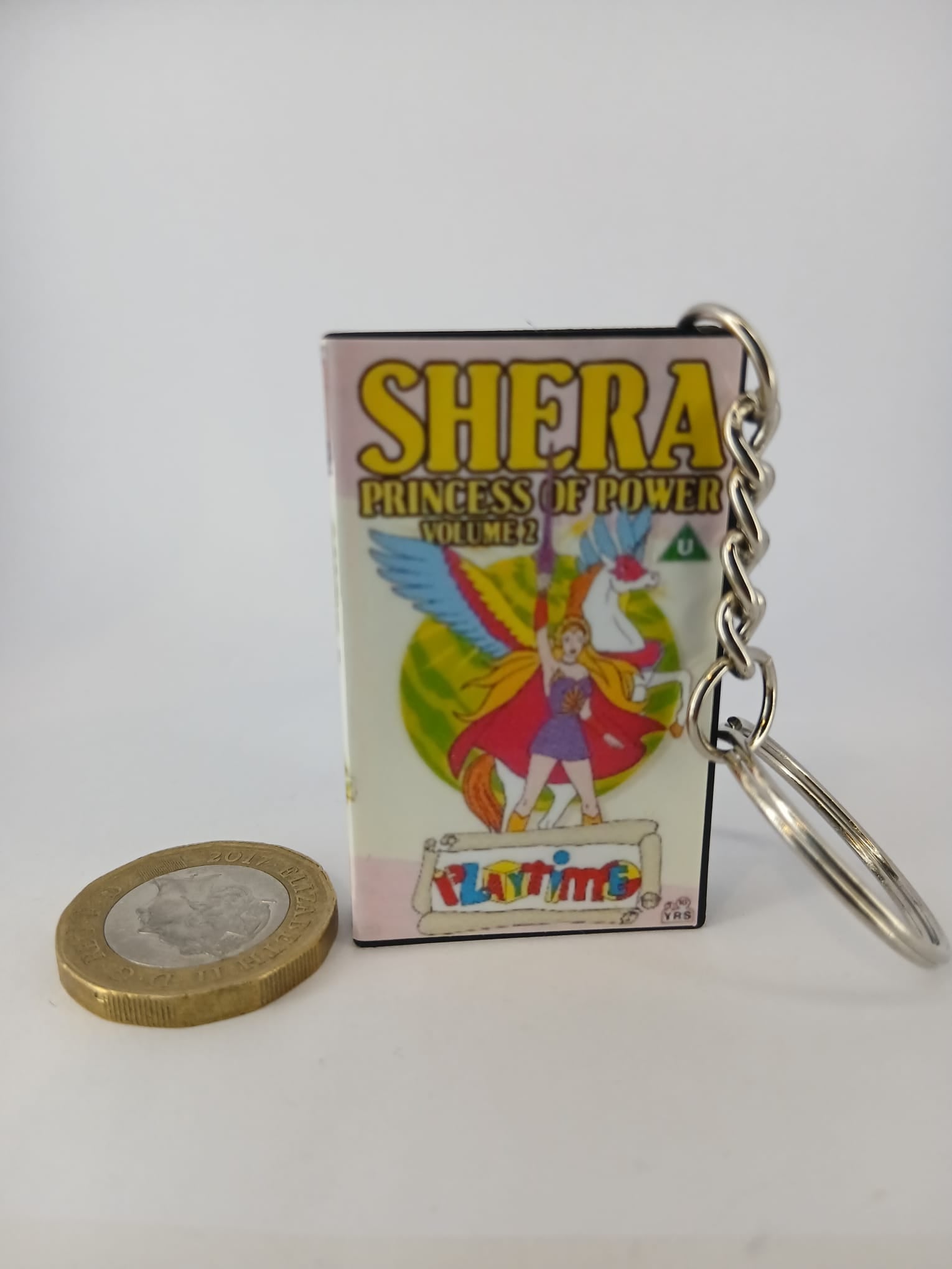 She-Ra Princess of Power VHS keyring — back and spine angled view standing