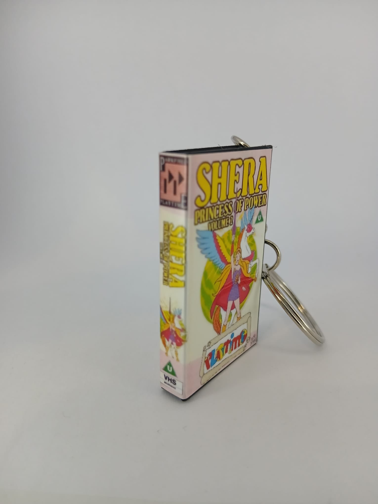 She-Ra Princess of Power VHS keyring — back cover standing angled