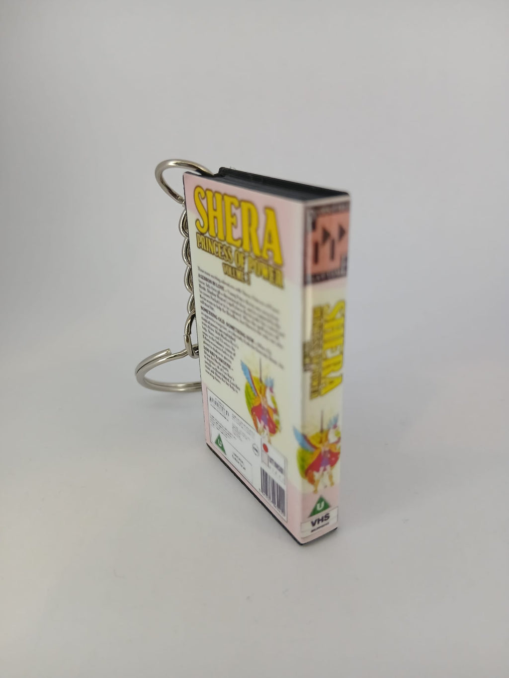 She-Ra Princess of Power VHS keyring — back cover standing angled 3