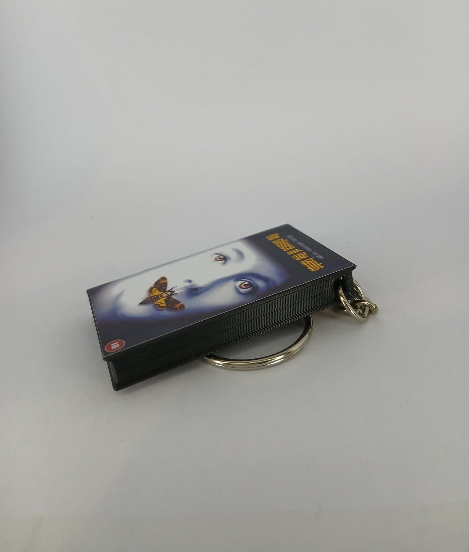 The Silence of the Lambs VHS keyring — back and spine angled view standing