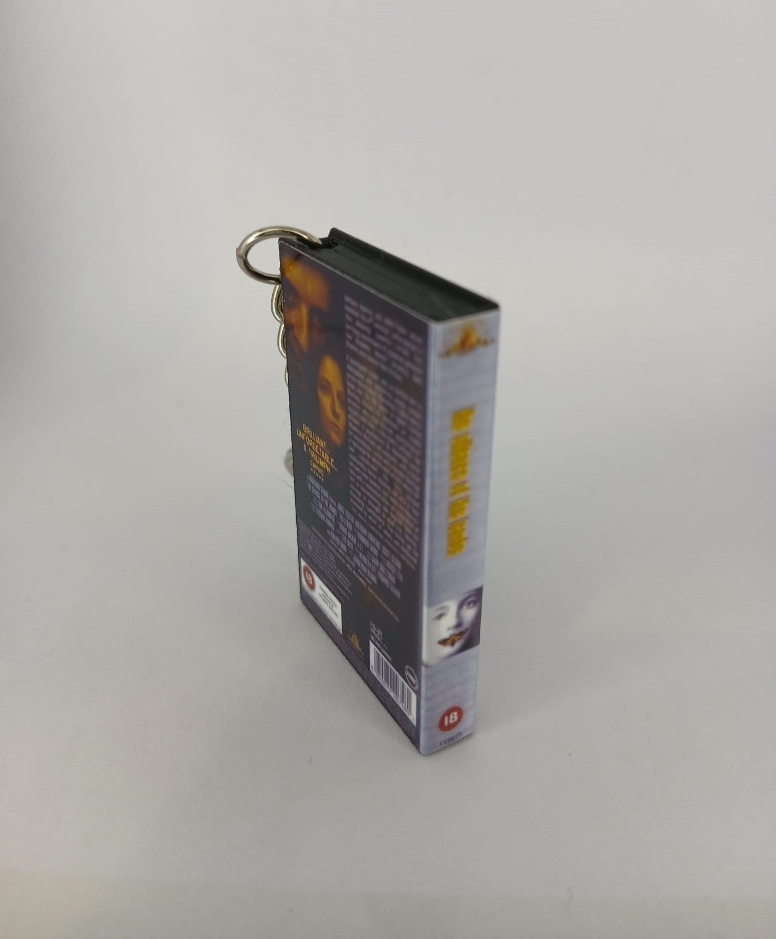 The Silence of the Lambs VHS keyring — front and spine angled view standing