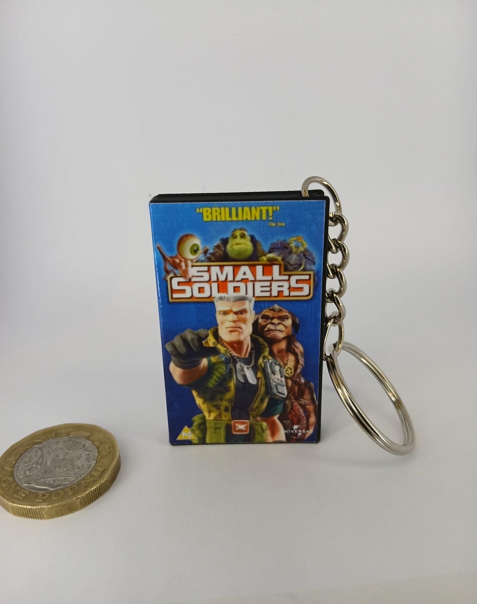 Small Soldiers VHS keyring — flat lay angled overhead