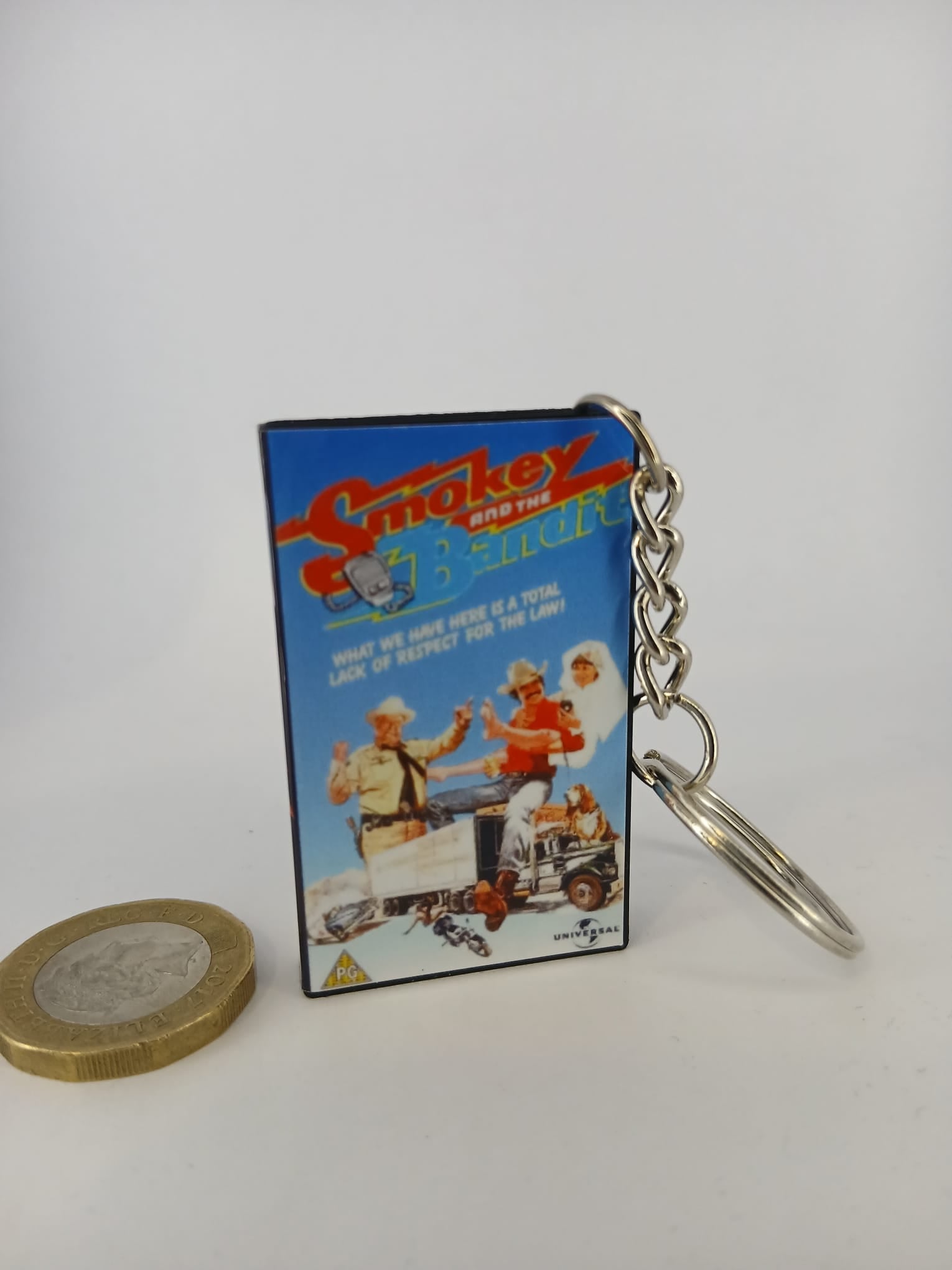 Smokey and the Bandit VHS keyring — front cover standing with coin for scale