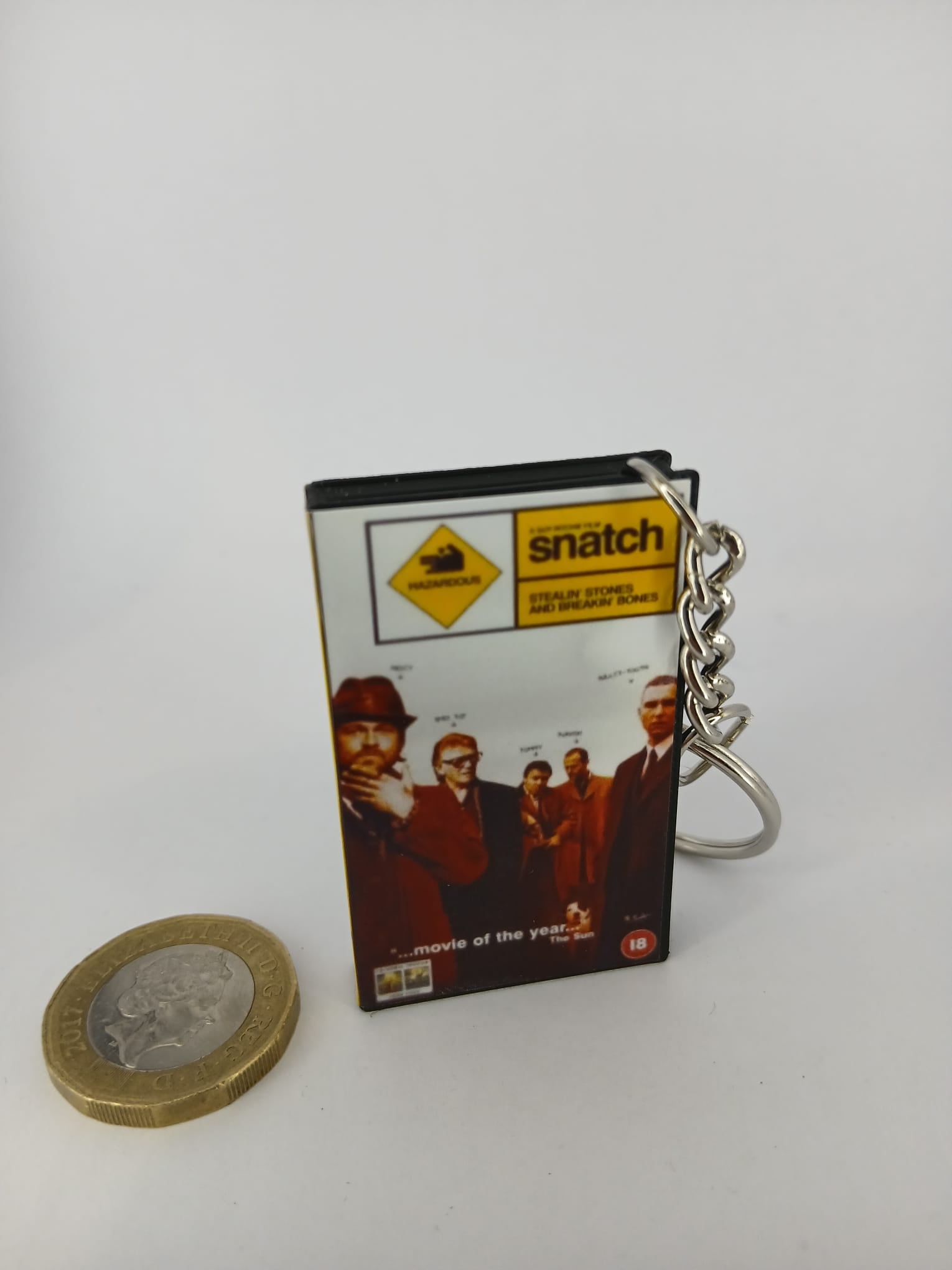 Snatch VHS keyring — back and spine angled view standing 2