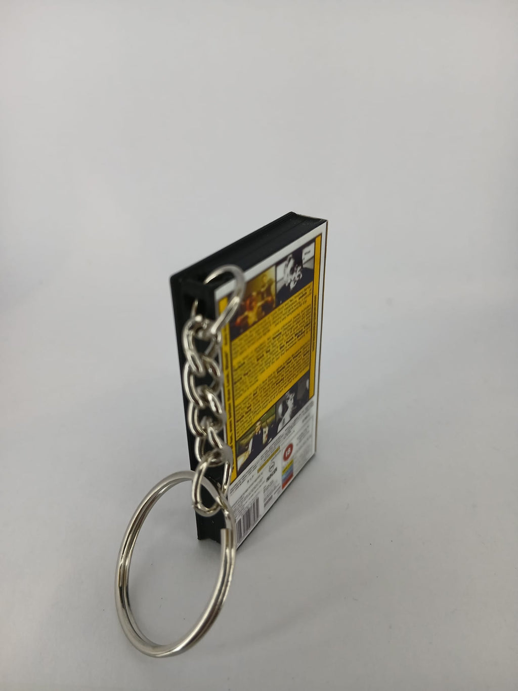 Snatch VHS keyring — front and spine angled view standing
