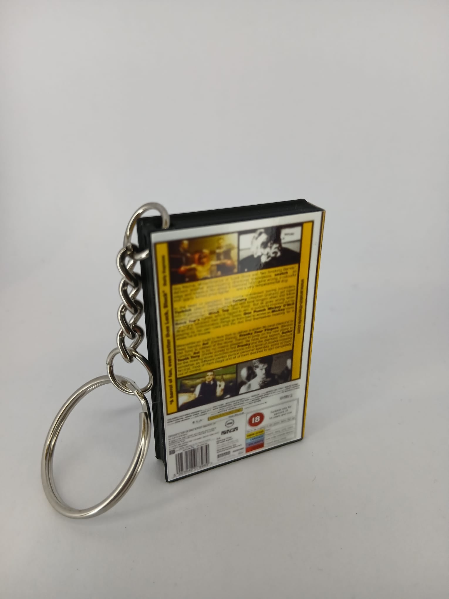 Snatch VHS keyring — front cover standing angled