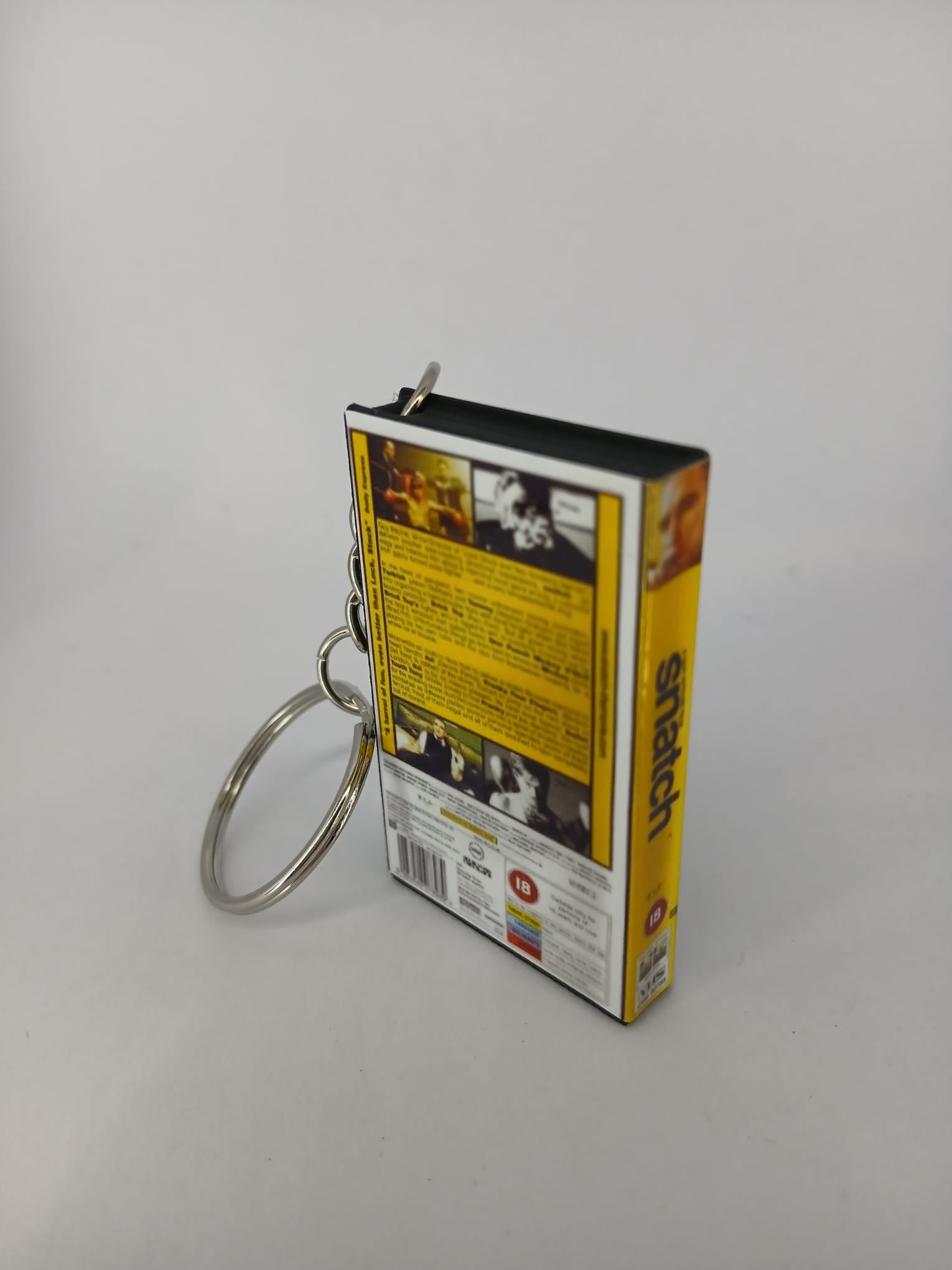 Snatch VHS keyring — front cover standing angled 2