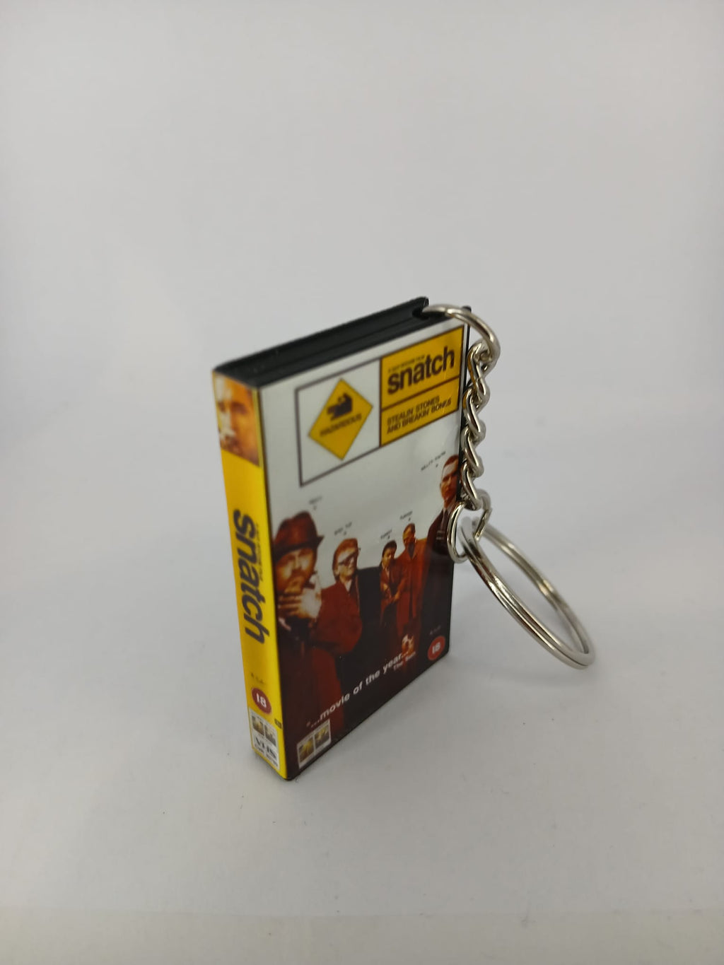 Snatch VHS keyring — front cover standing angled 3
