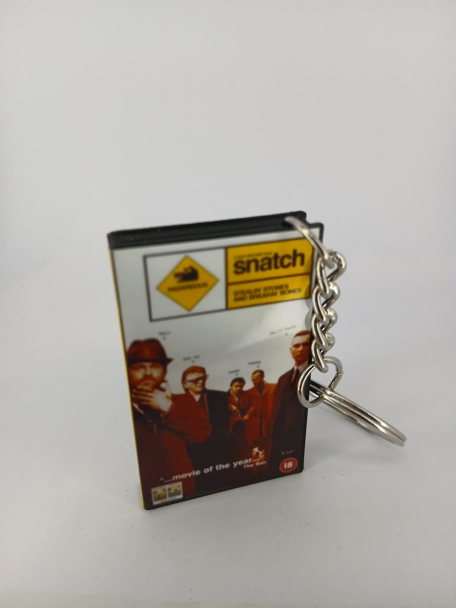 Snatch VHS keyring — back cover standing with full cast credits visible