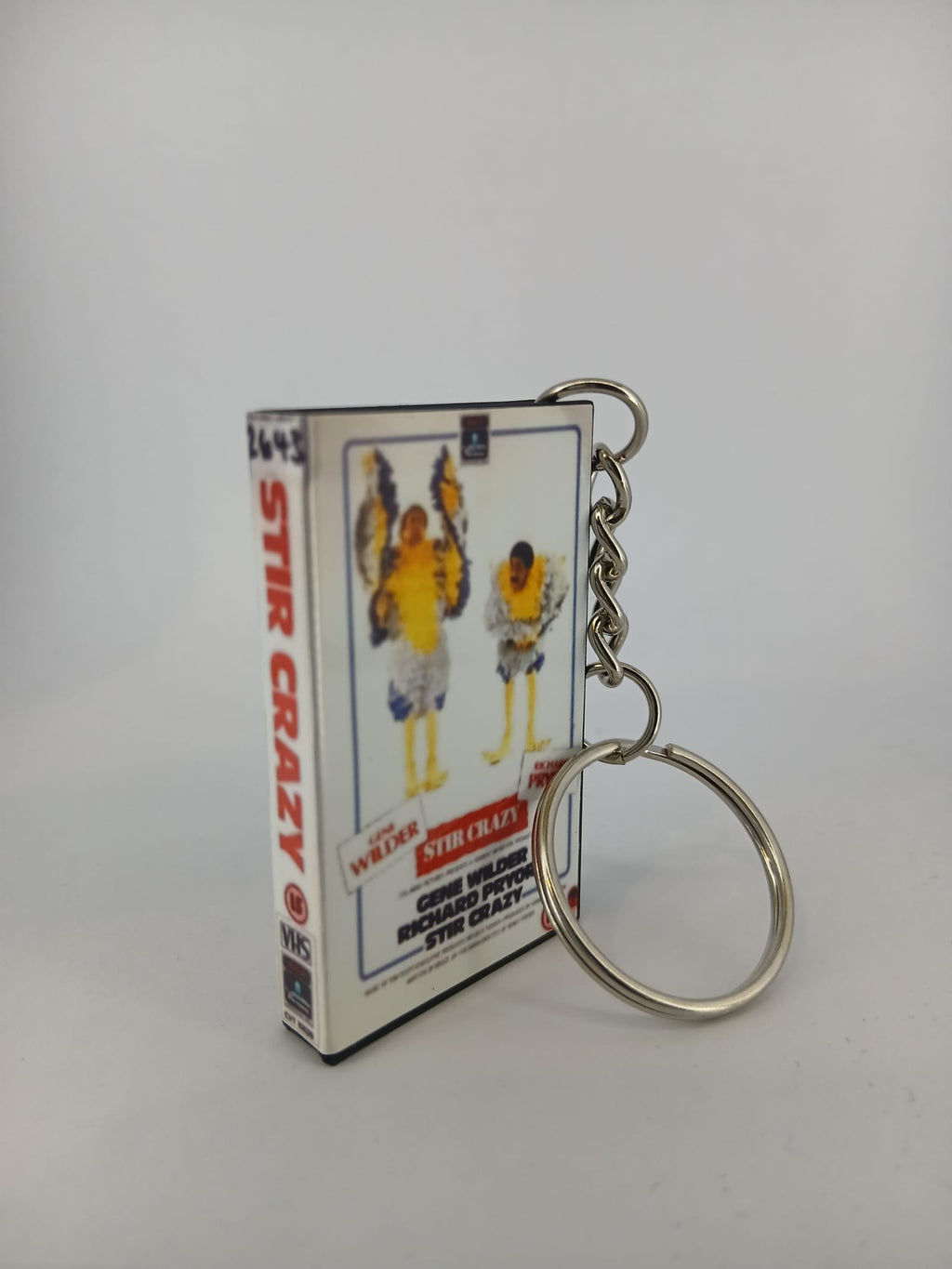 Stir Crazy VHS keyring — spine view standing