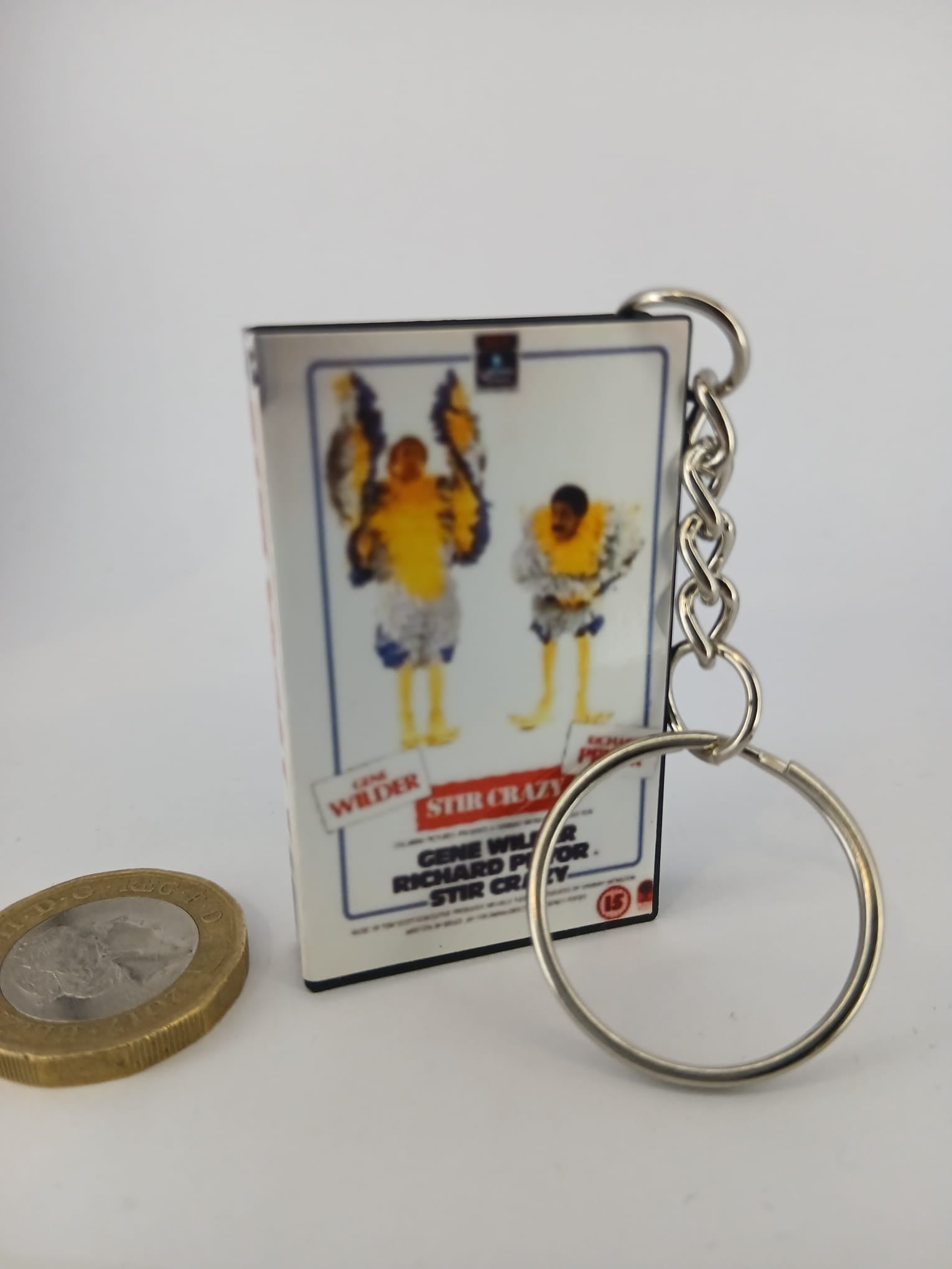 Stir Crazy VHS keyring — back cover angled view standing