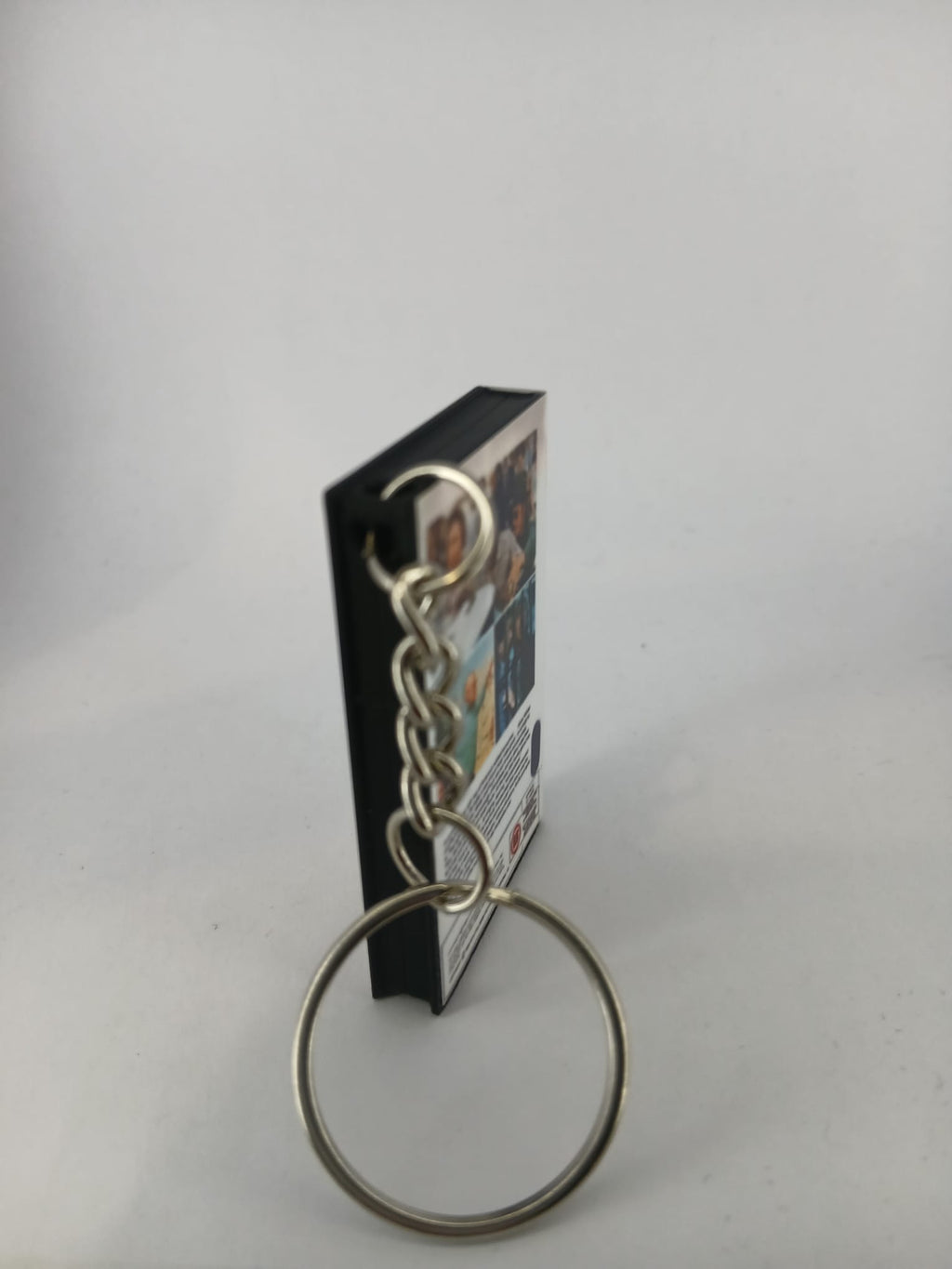 Stir Crazy VHS keyring — back and spine angled view standing