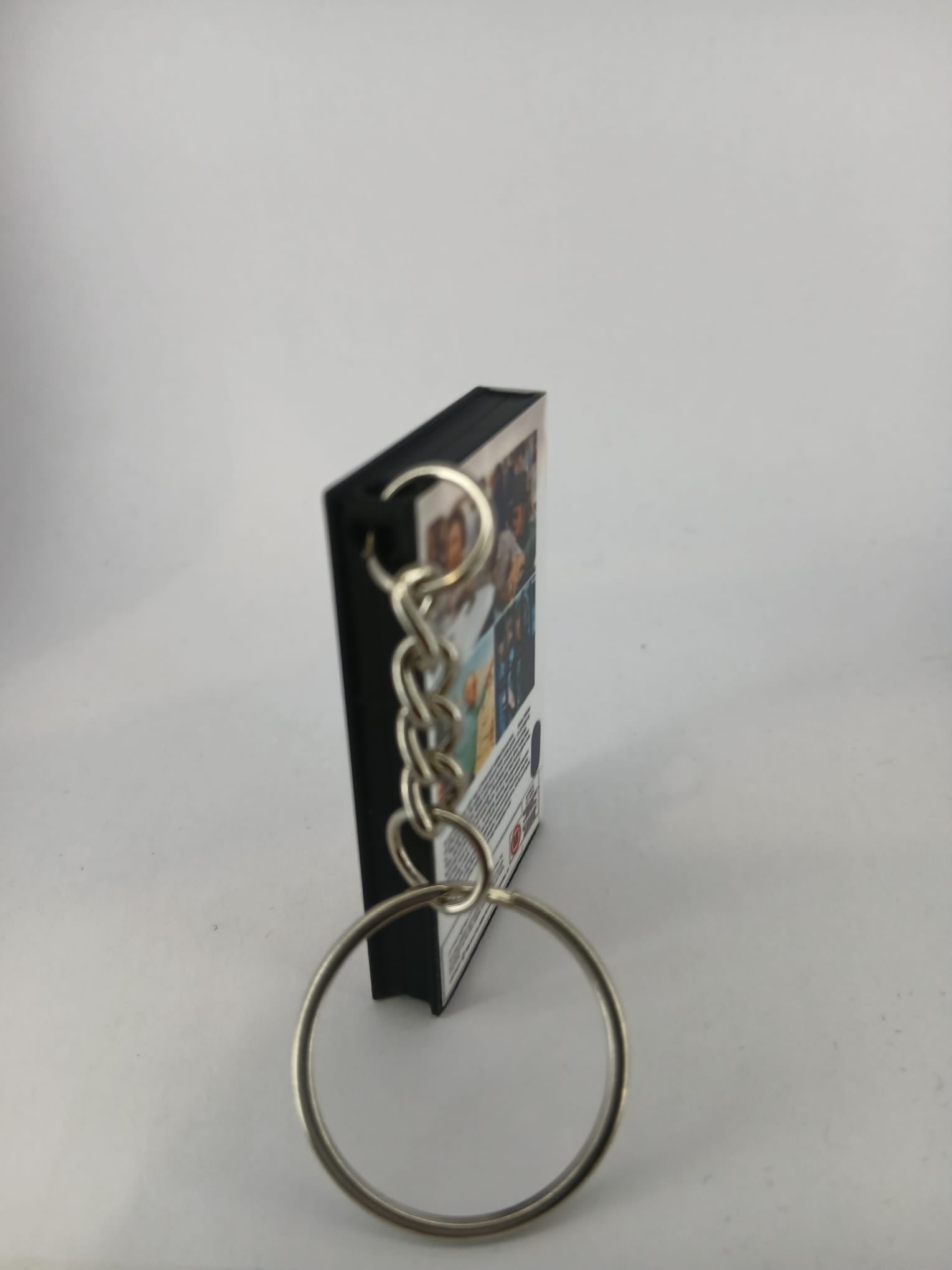 Stir Crazy VHS keyring — back and spine angled view standing