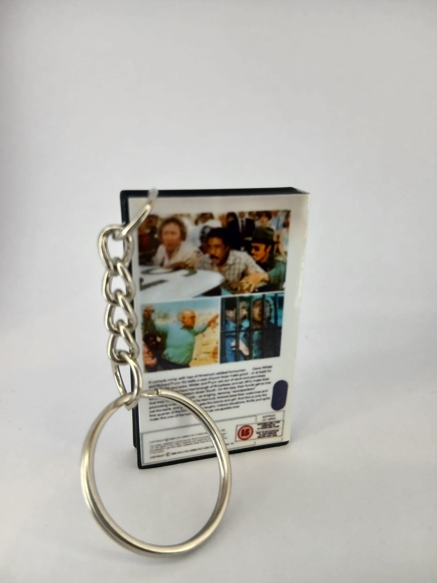 Stir Crazy VHS keyring — flat lay front and spine angled