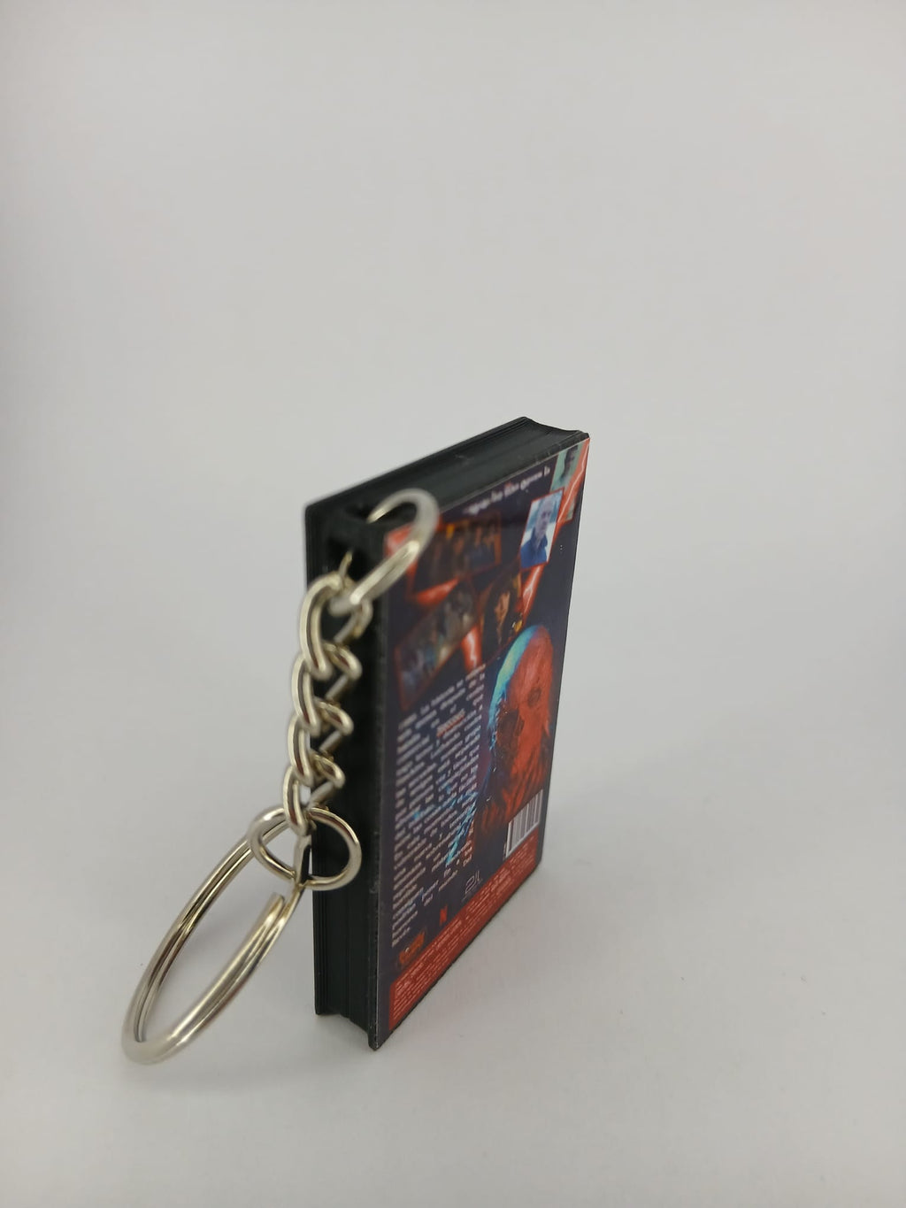 Stranger Things S4 Vol.1 VHS keyring — spine and back angled view standing