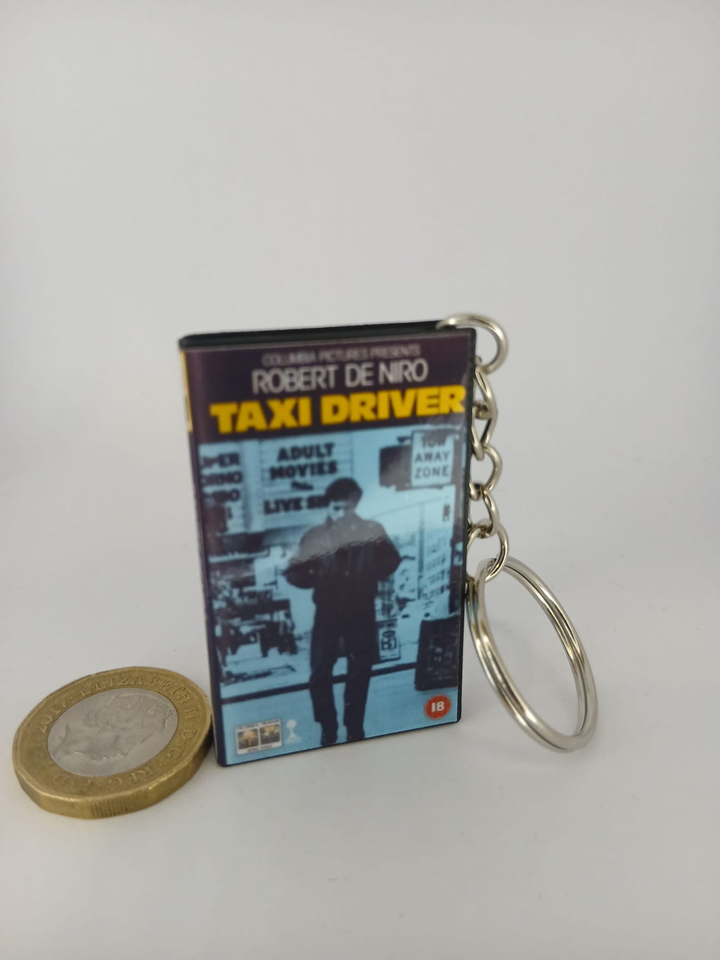 Taxi Driver VHS keyring — front cover with £1 coin for scale