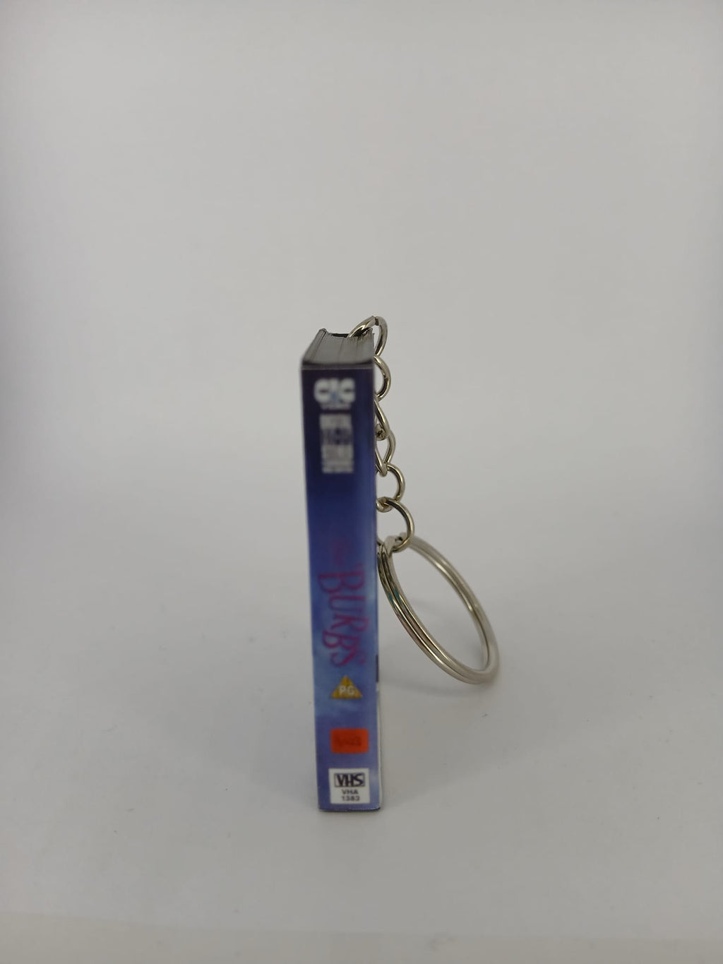 The 'Burbs VHS keyring — back cover standing angled