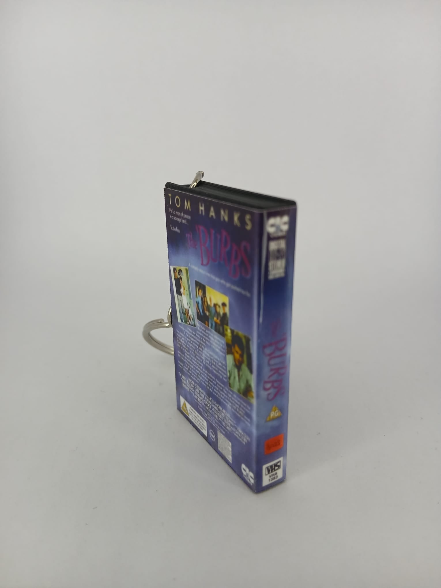 The 'Burbs VHS keyring — front cover flat lay angled