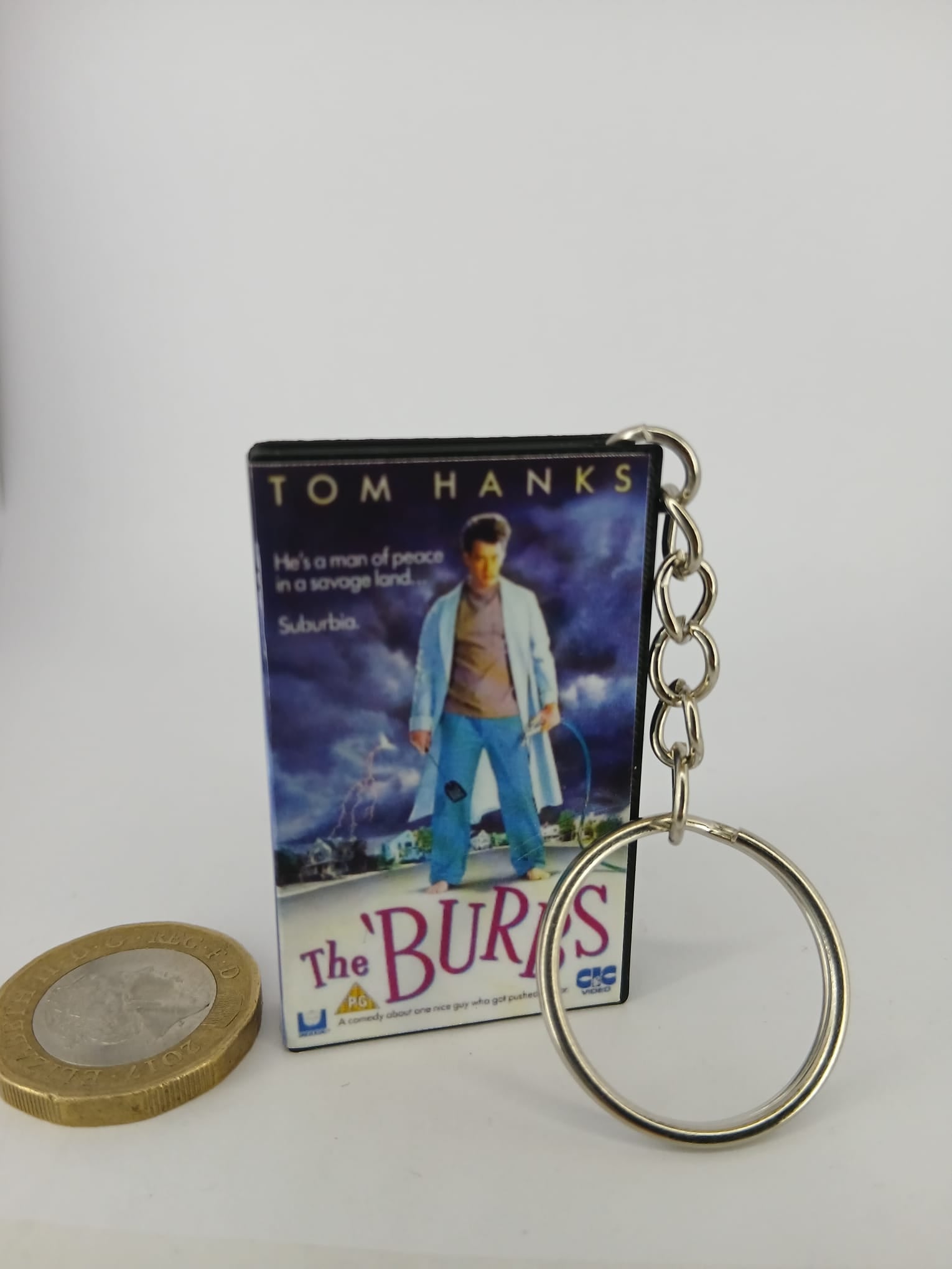 The 'Burbs VHS keyring — front cover flat lay angled 2