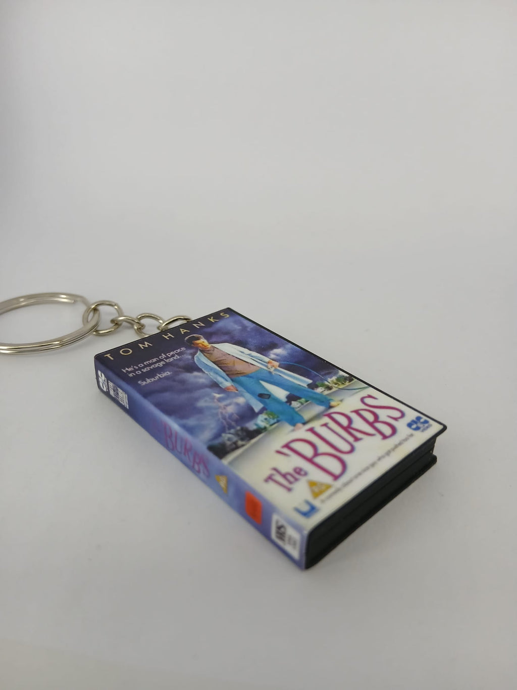 The 'Burbs VHS keyring — front cover flat lay angled 4