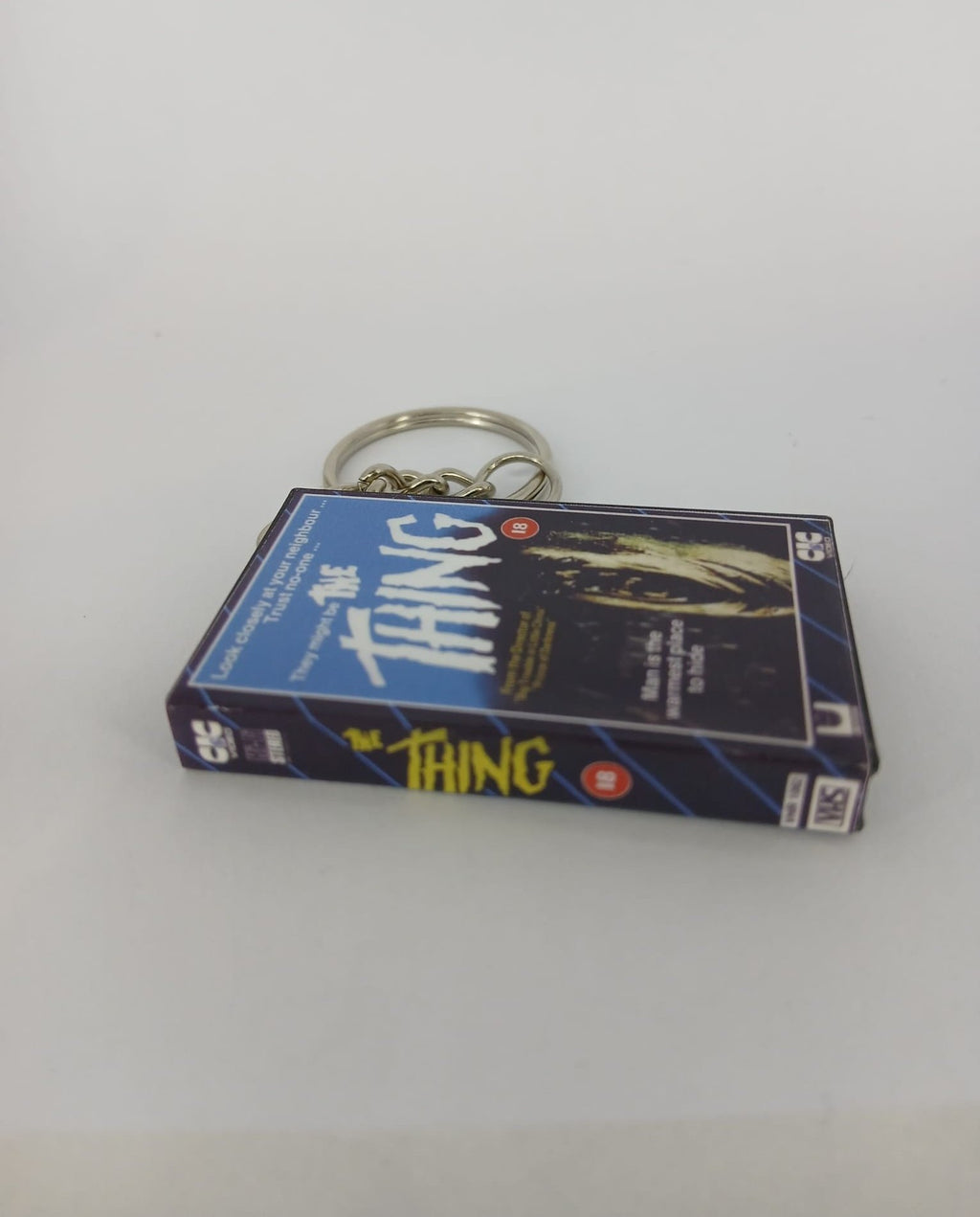 The Thing Mini VHS Keyring – flat lay overhead