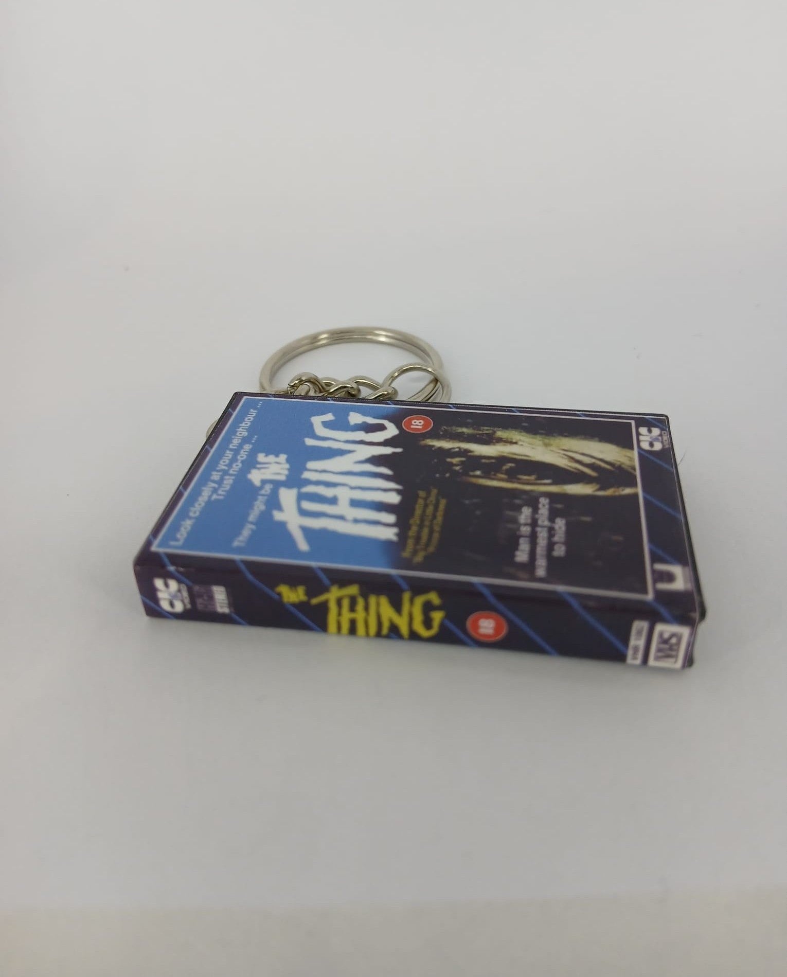 The Thing Mini VHS Keyring – flat lay overhead