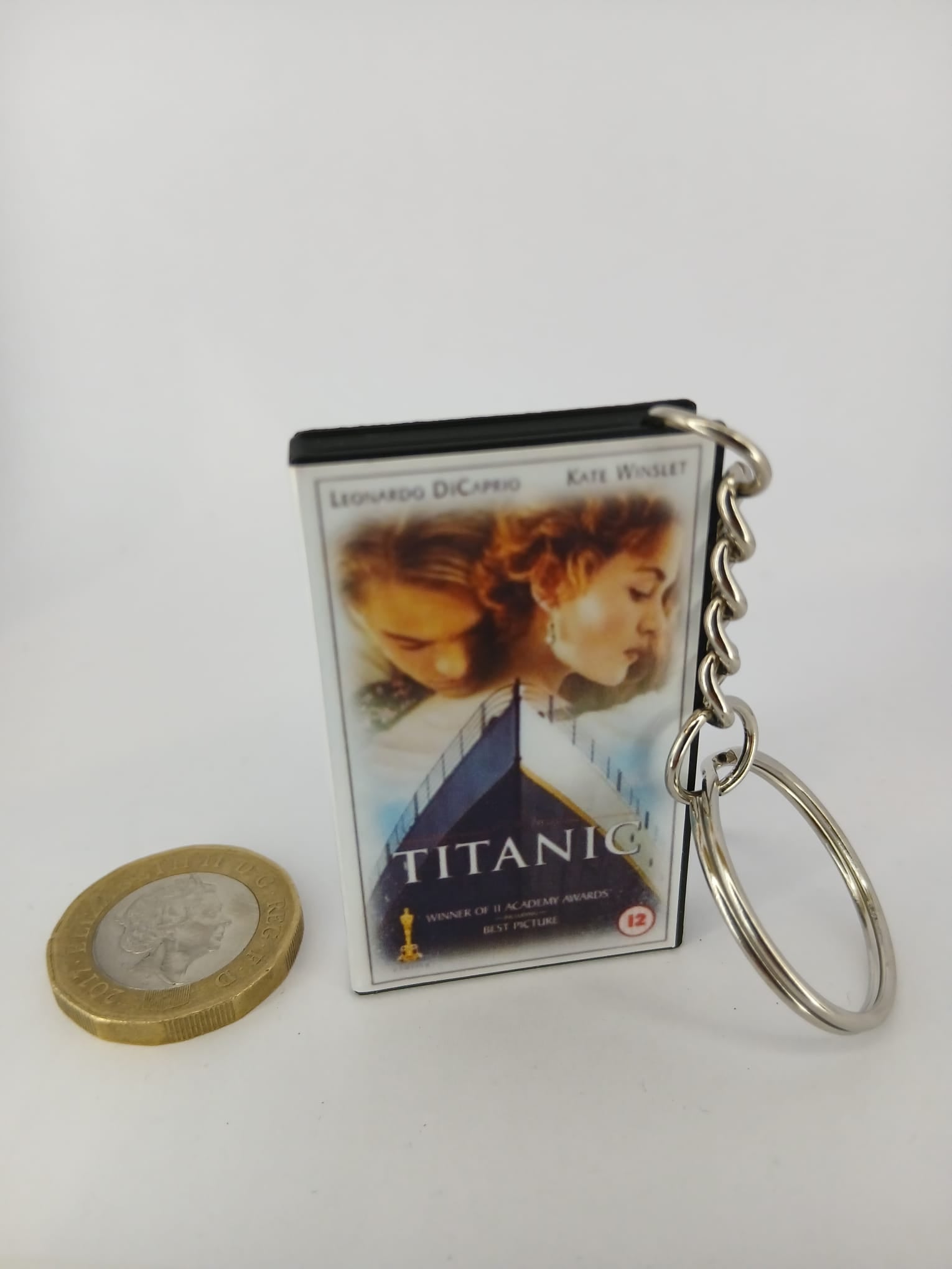 Titanic VHS keyring — front cover standing with coin for scale