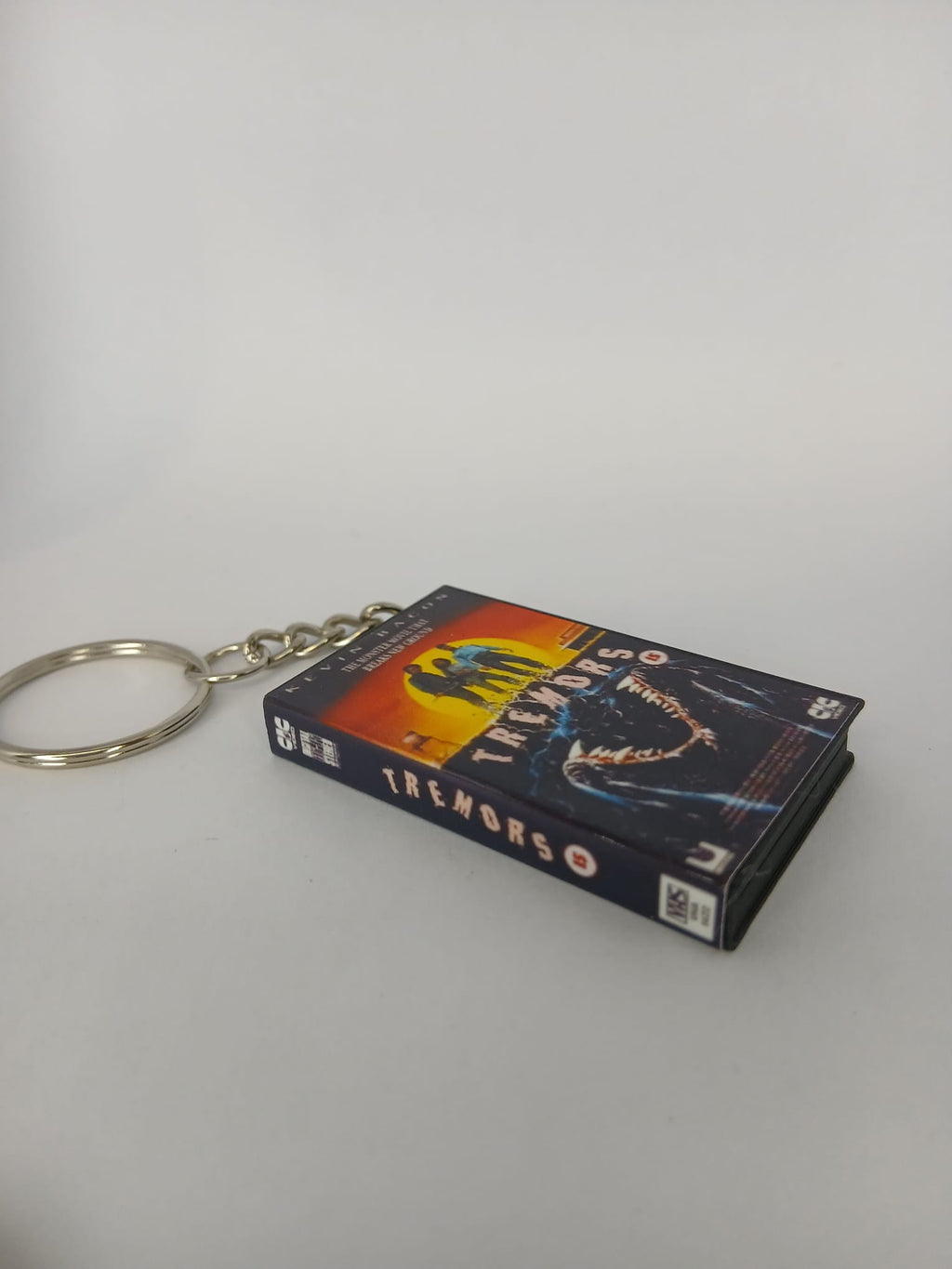 Tremors Mini VHS Keyring – back spine angle standing