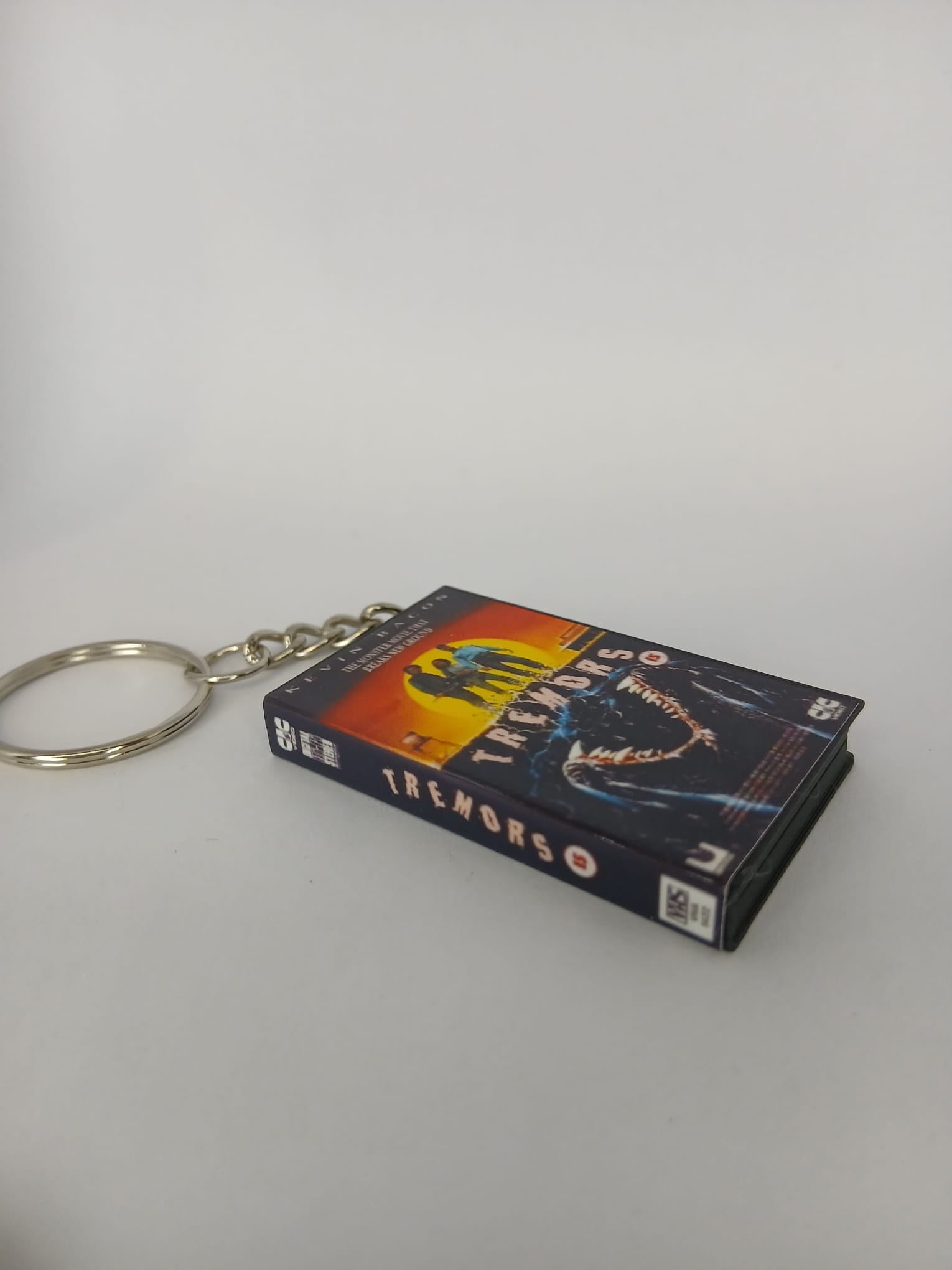 Tremors Mini VHS Keyring – back spine angle standing