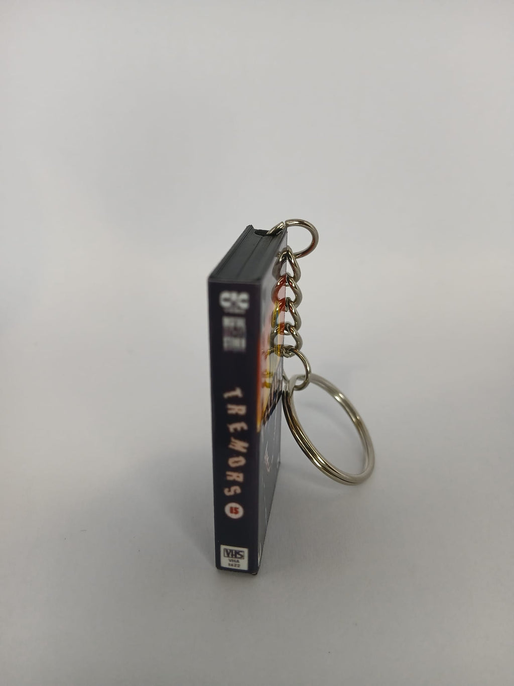 Tremors Mini VHS Keyring – front spine angle standing