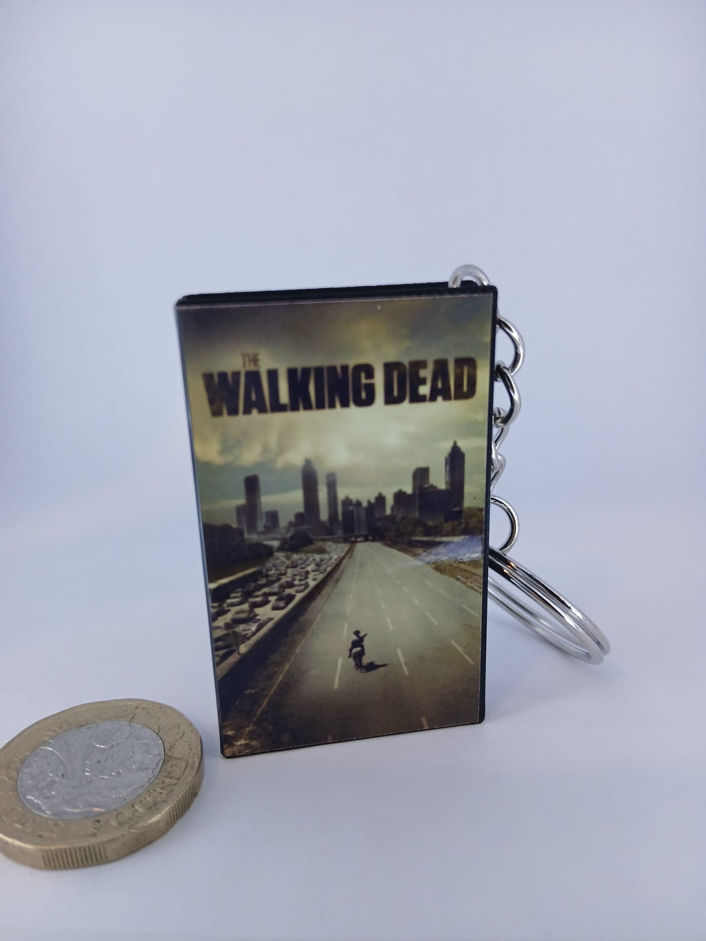 The Walking Dead VHS keyring — front cover with £1 coin for scale