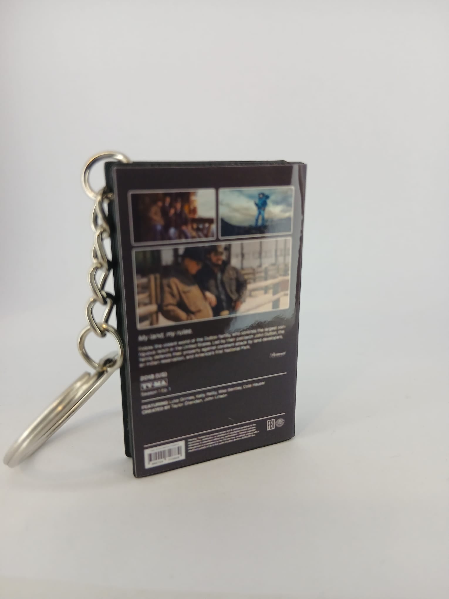 Yellowstone VHS keyring — back cover angled view standing