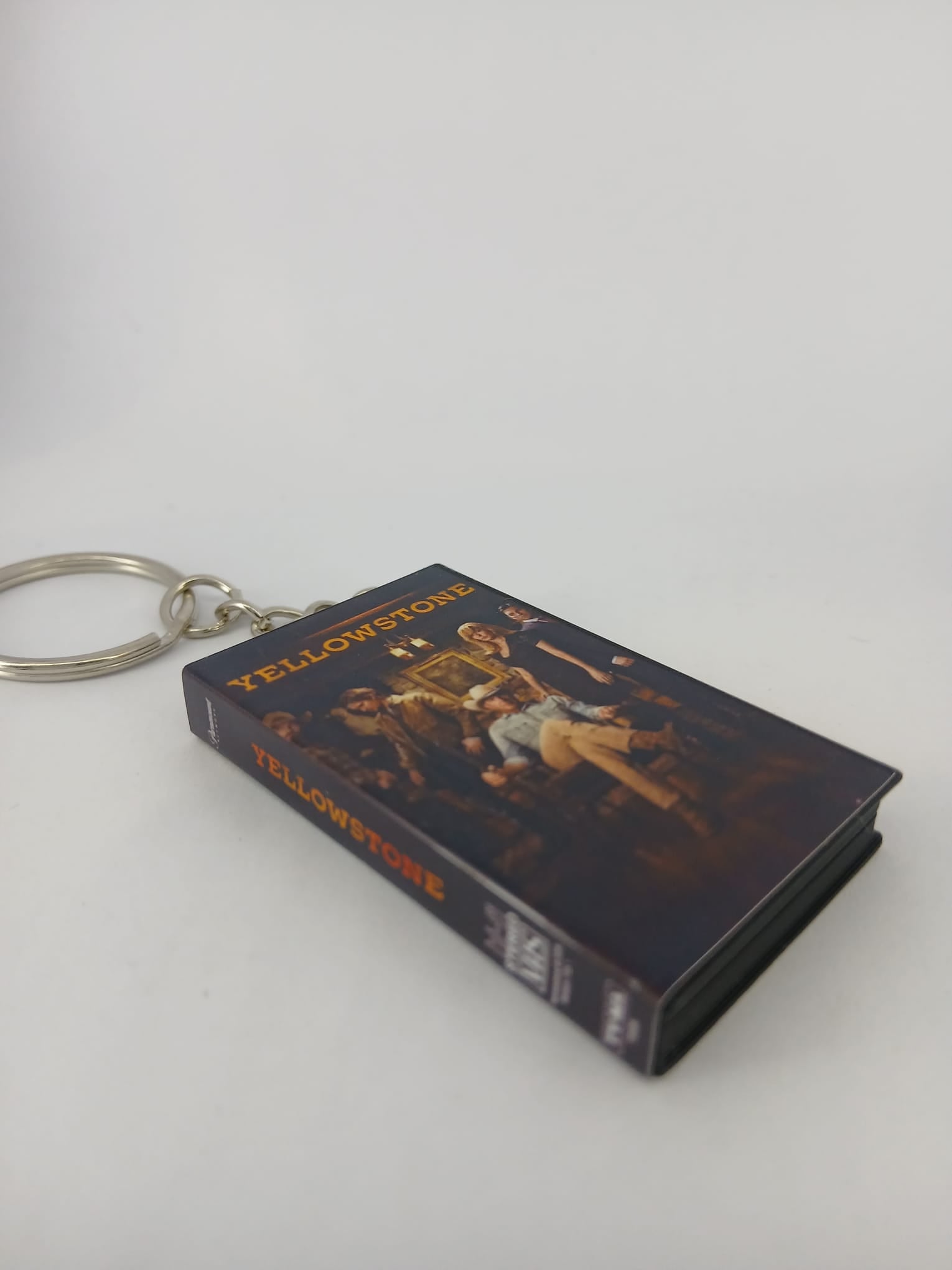 Yellowstone VHS keyring — spine and front angled view standing
